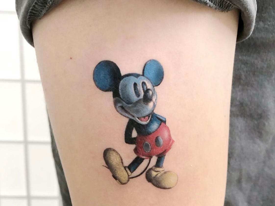 colorful Mickey mouse tattoo on upper arm