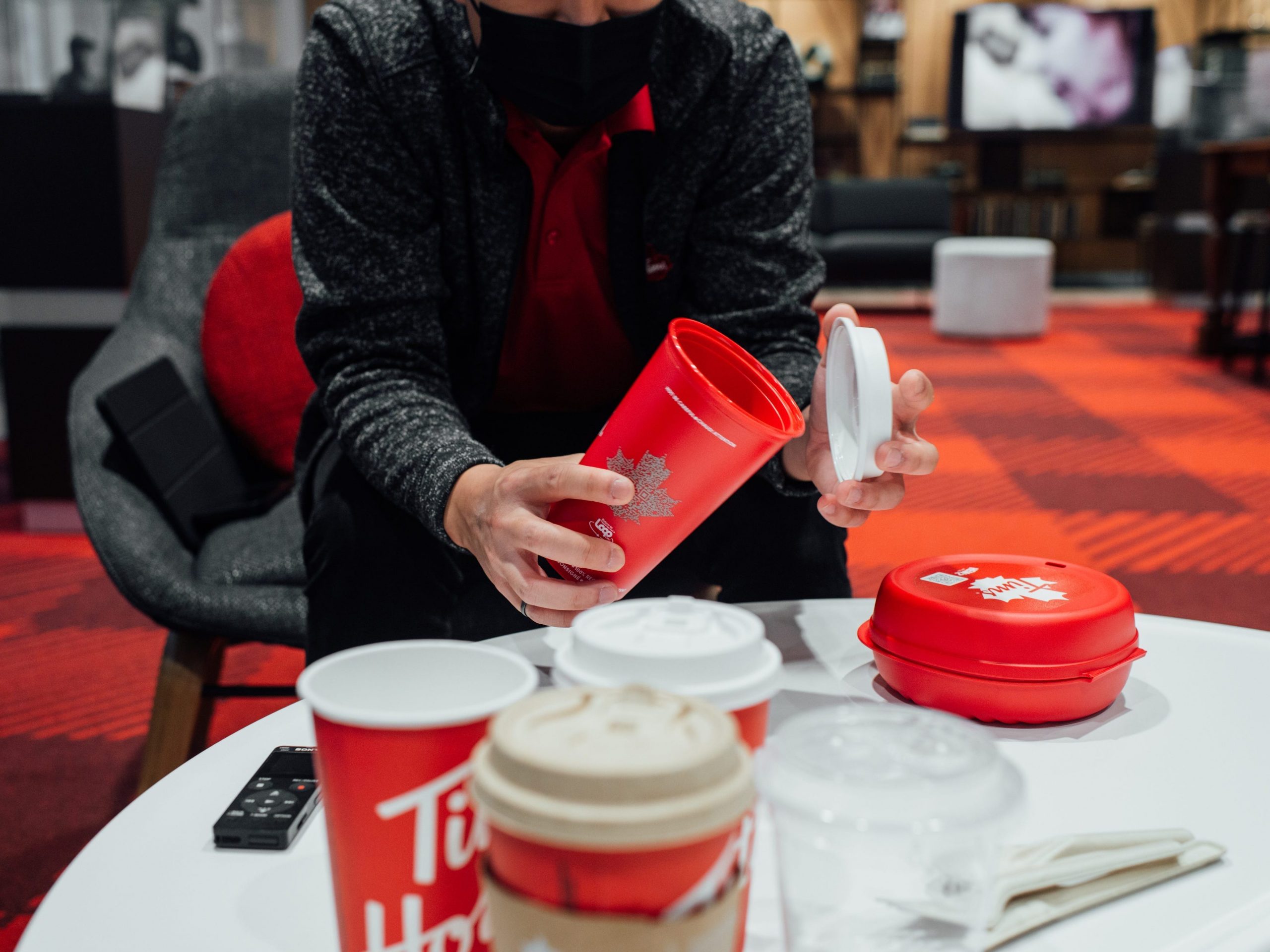 Tim Horton's Paul Yang shows off some of the new reusable and recyclable drink containers at the company's Toronto headquarters.