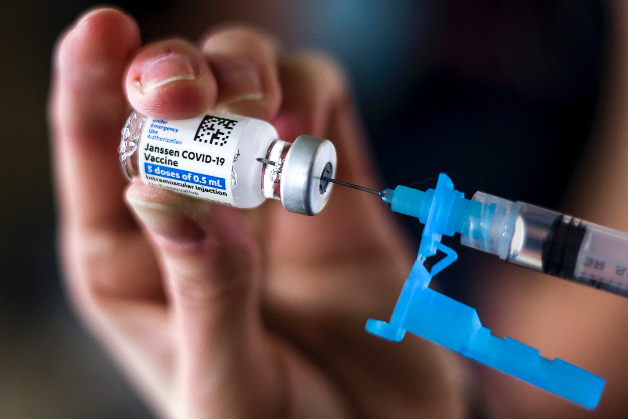 A nurse draws a dose from a vial of the Johnson & Johnson COVID-19 vaccine.