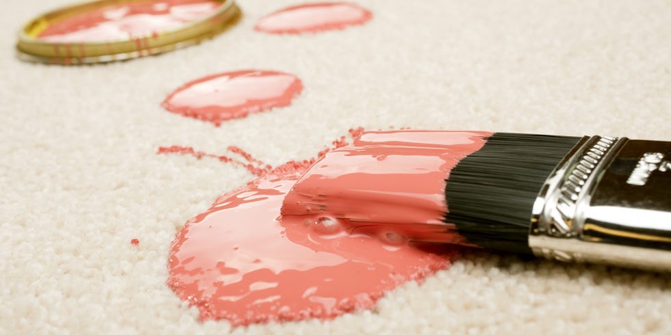 Pink paint splattered on a carpet.