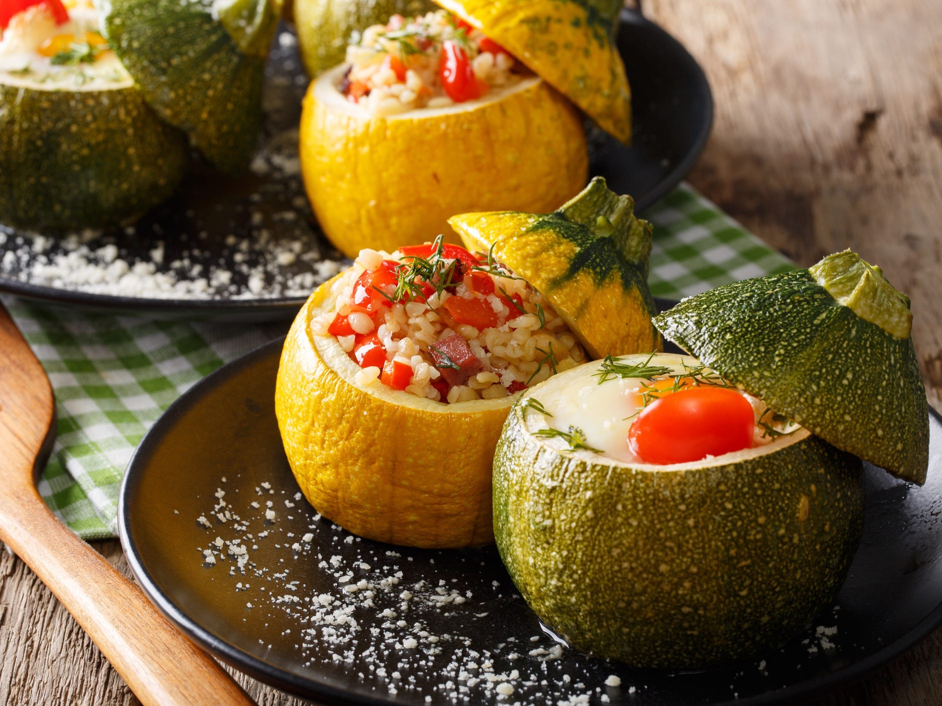 Yellow and green ball zucchini baked and stuffed with rice and veggies