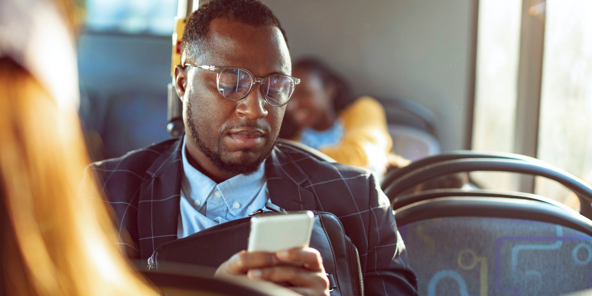 Commuter on bus looking at phone