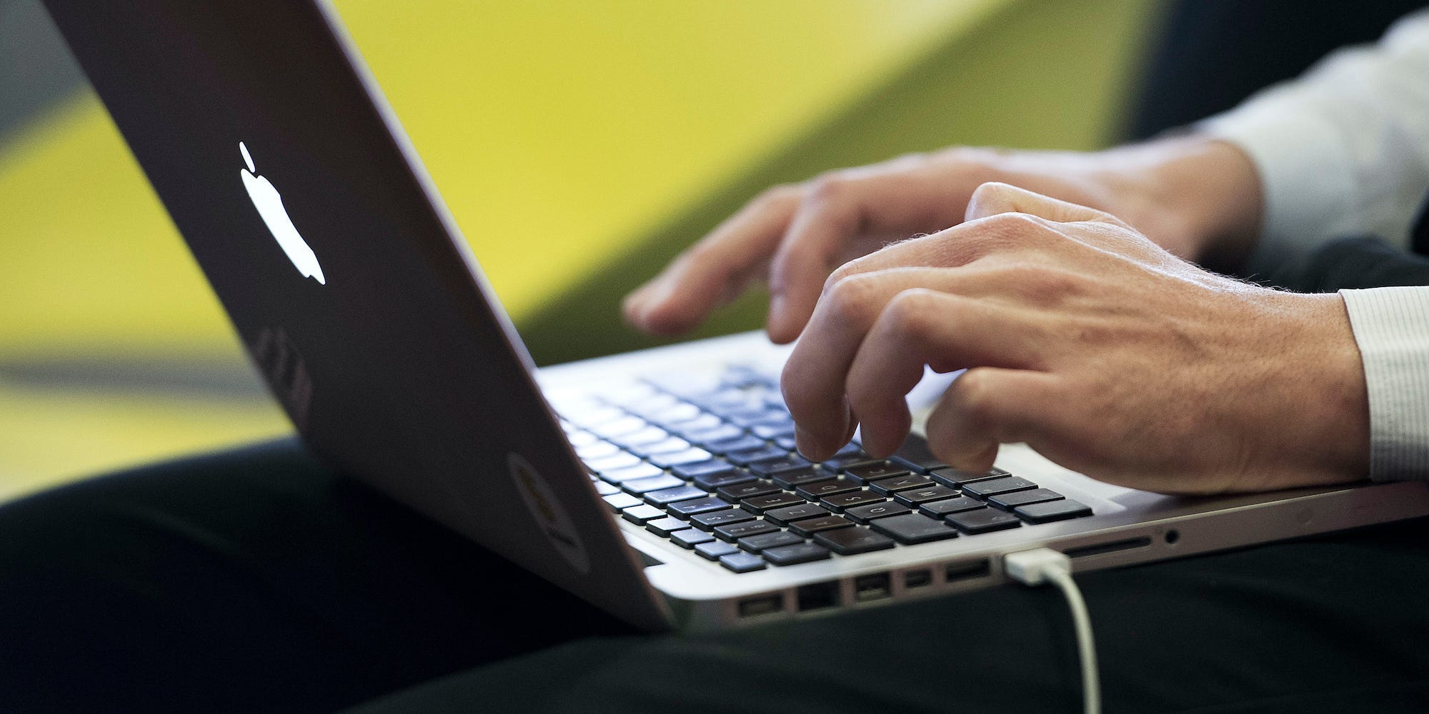 a person types on a laptop