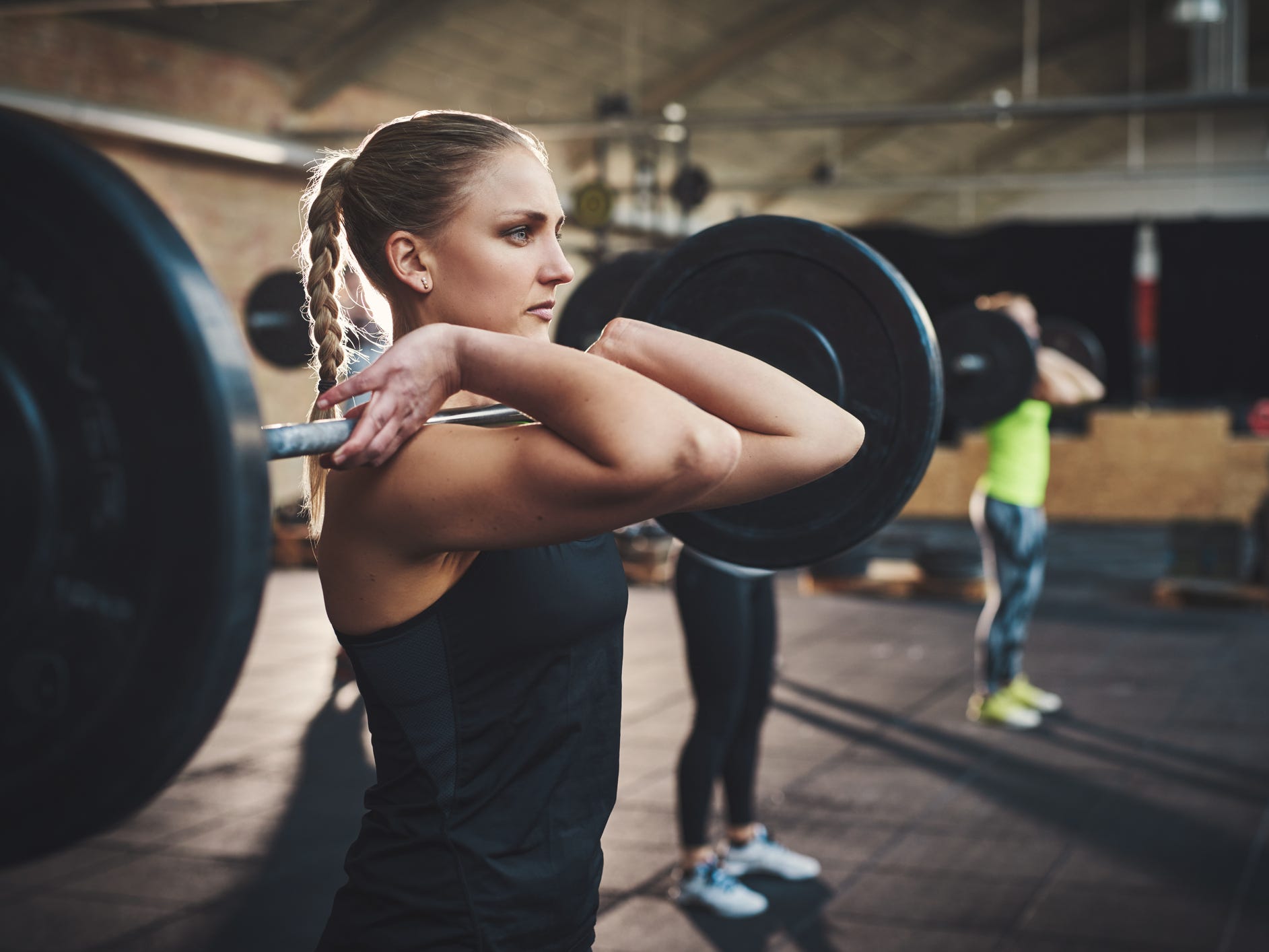 an athlete holding a barbell in a front rack position