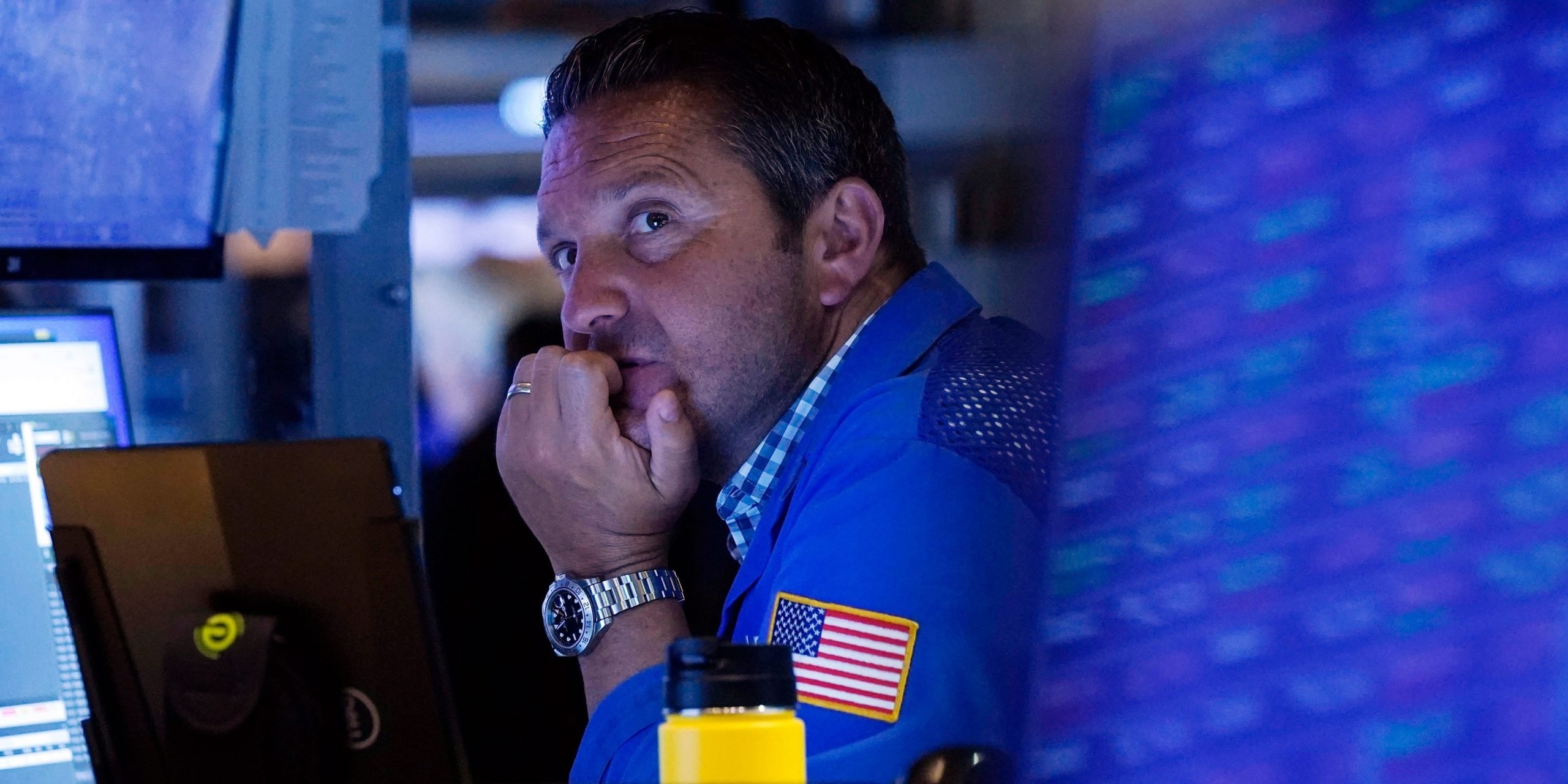 A trader sits in front of a computer monitor on the floor of the New York Stock Exchange.