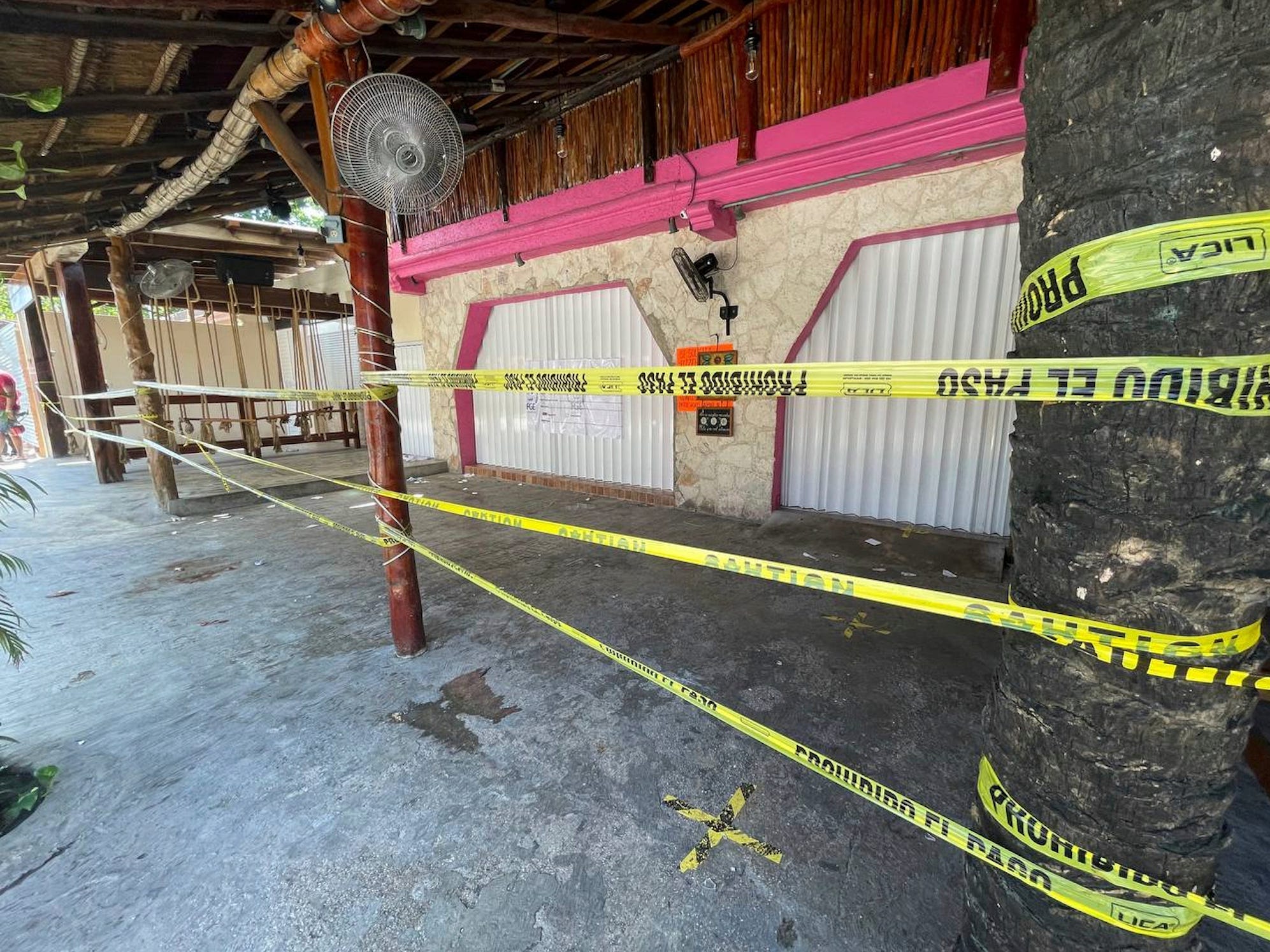 Police security tape covers the exterior of a restaurant the day after a fatal shooting in Tulum, Mexico, Friday, Oct. 22, 2021.