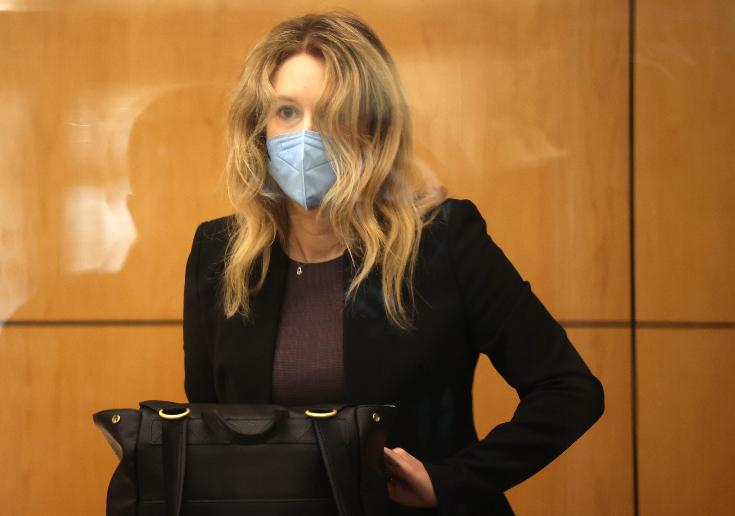 Theranos founder Elizabeth Holmes in a black suit jacket in a San Jose courtroom