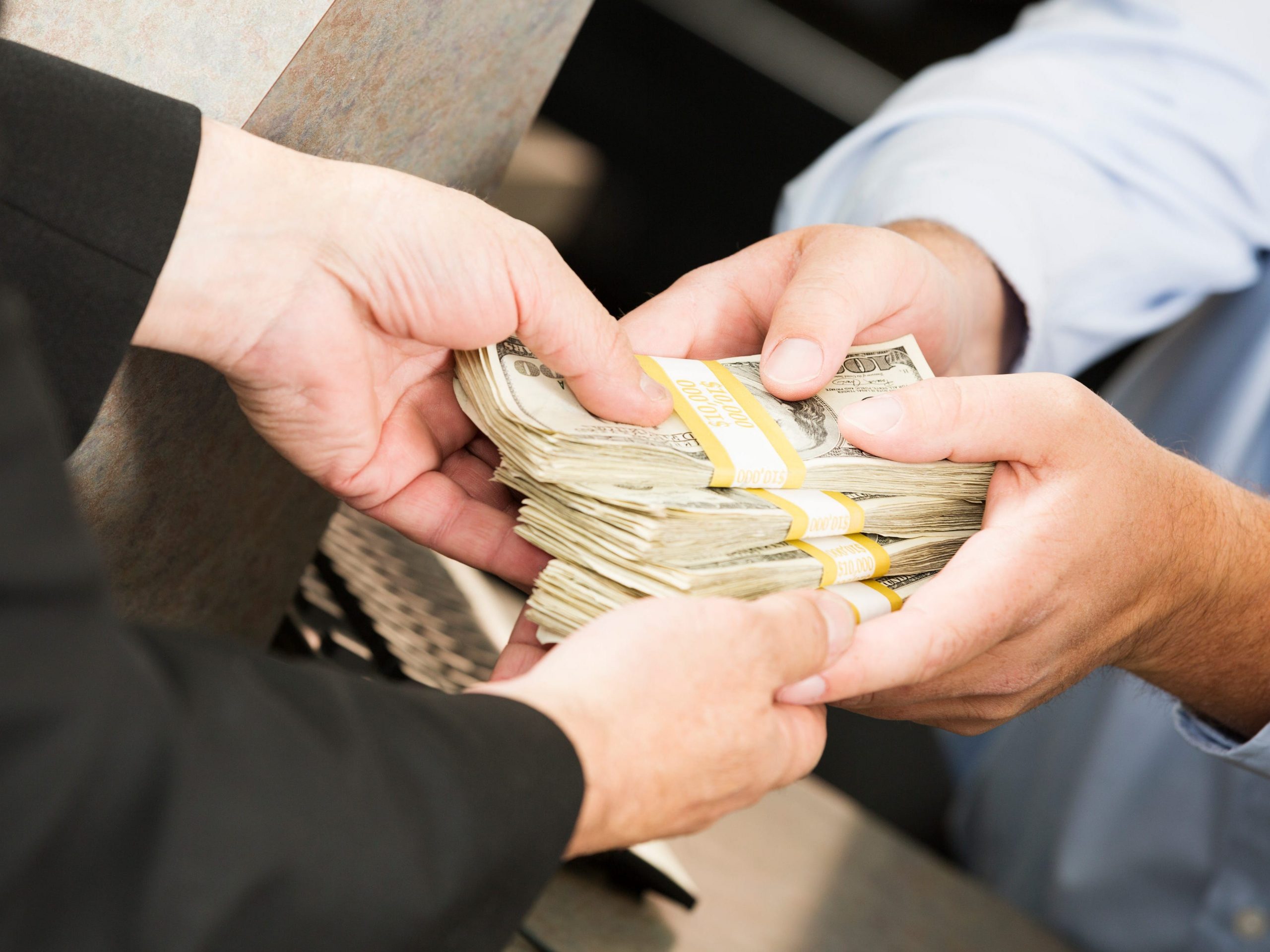 Stock image of a large sum of money exchanging hands