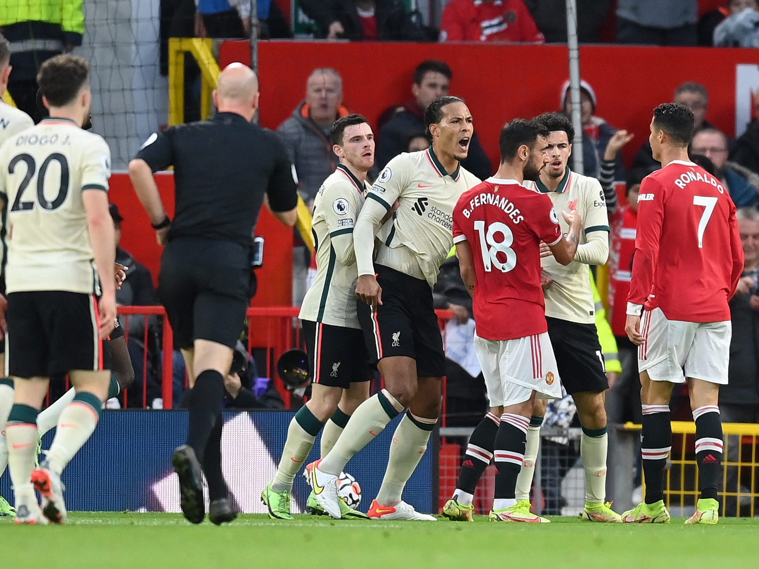 Liverpool players react angrily to a foul by Cristiano Ronaldo.