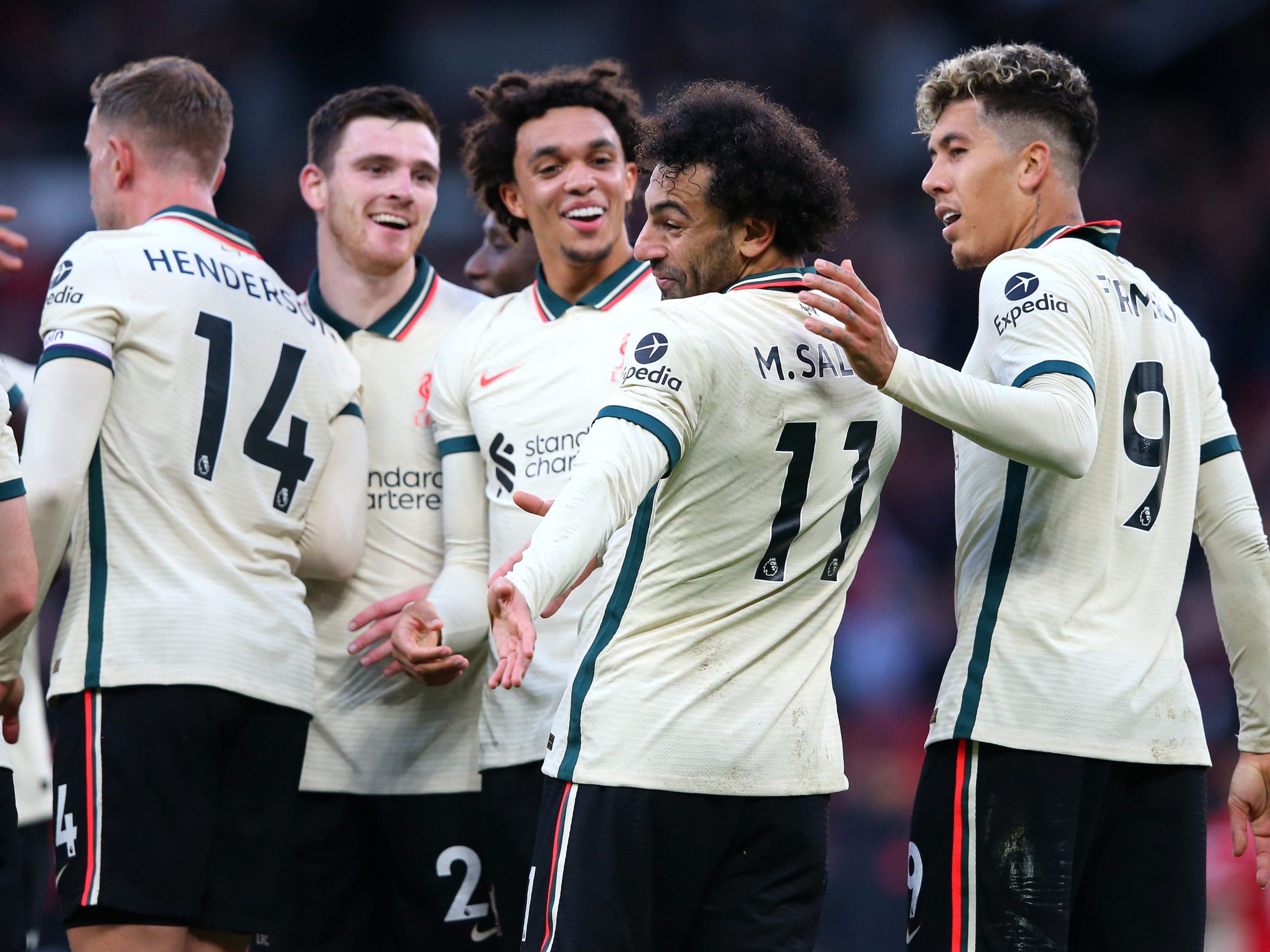 Liverpool players celebrate after scoring a goal.