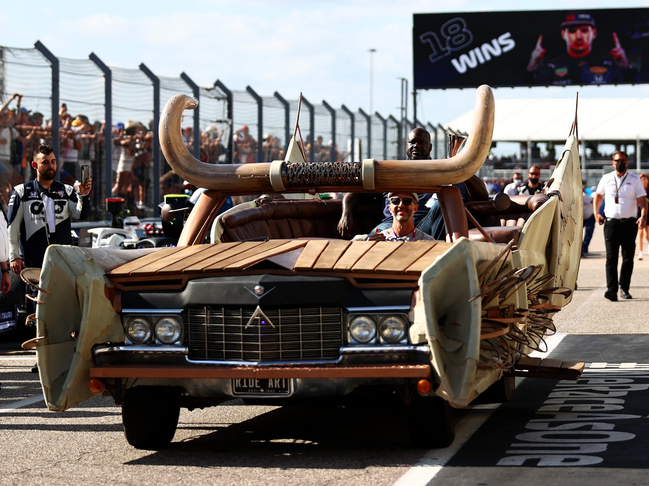 NBA legend Shaquille O'Neal brings the race winners trophy to the podium during the F1 Grand Prix of USA.