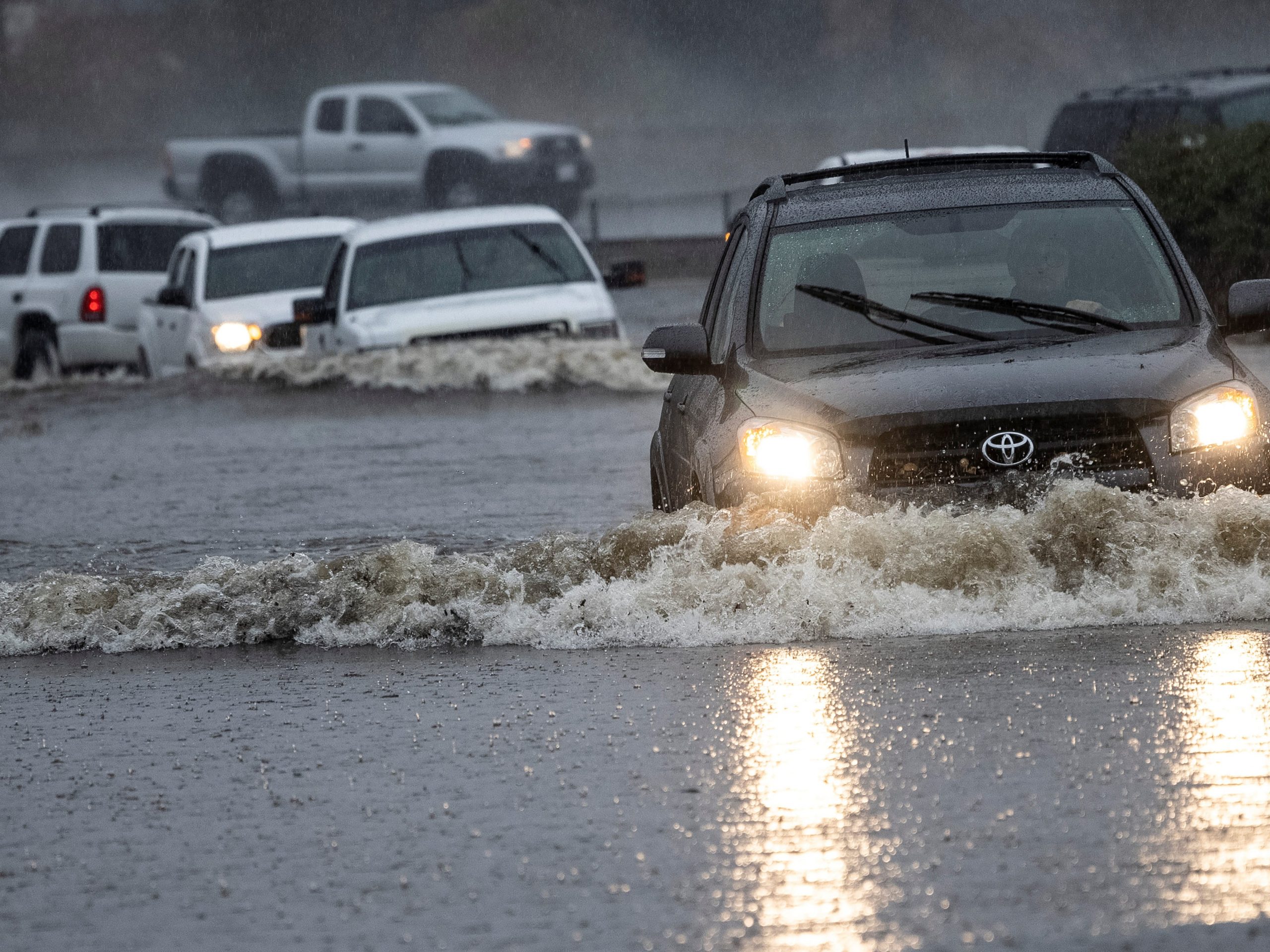 Vehicles drive through a flooded area as a powerful storm drenched northern California in Fairfield, California, U.S. October 24, 2021.