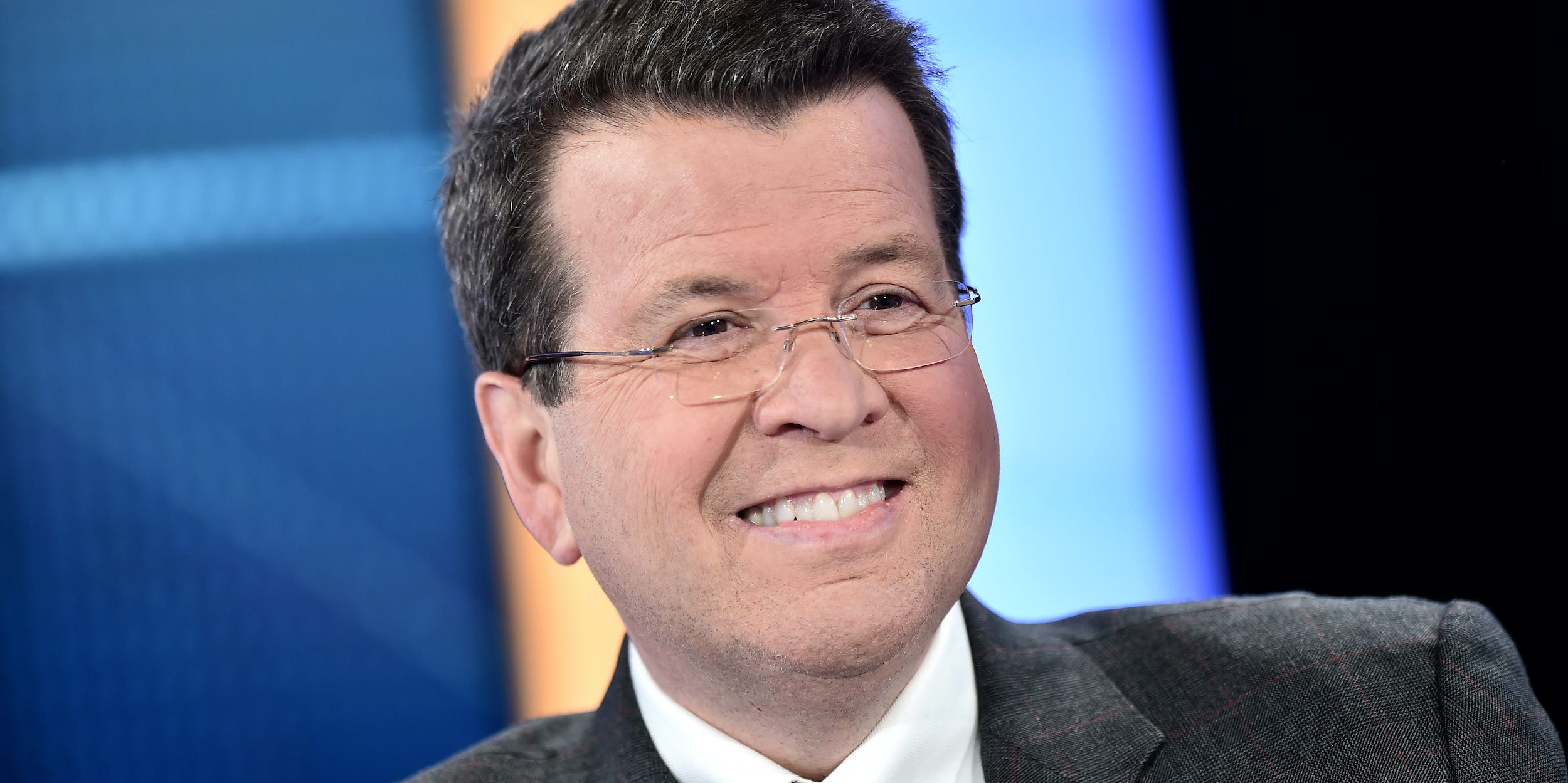 Neil Cavuto smiles on set at the Fox Business studios.