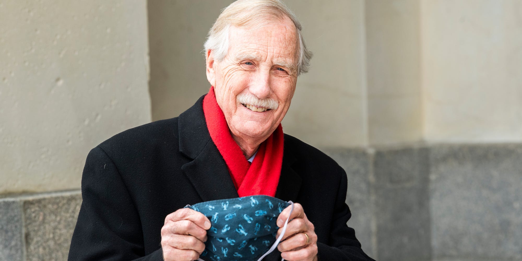 Independent Sen. Angus King of Maine shows off his lobster mask upon arriving to the Capitol on the fourth day of former President Donald Trump’s impeachment trial on Friday, February 12, 2021.