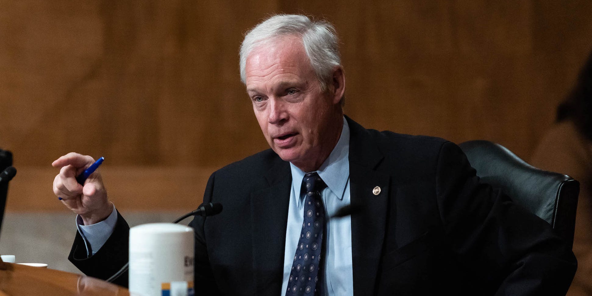 Sen. Ron Johnson sitting and a table and pointing.