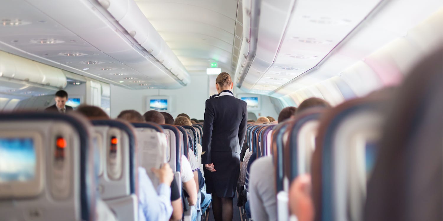 A flight attendant on an airplane.