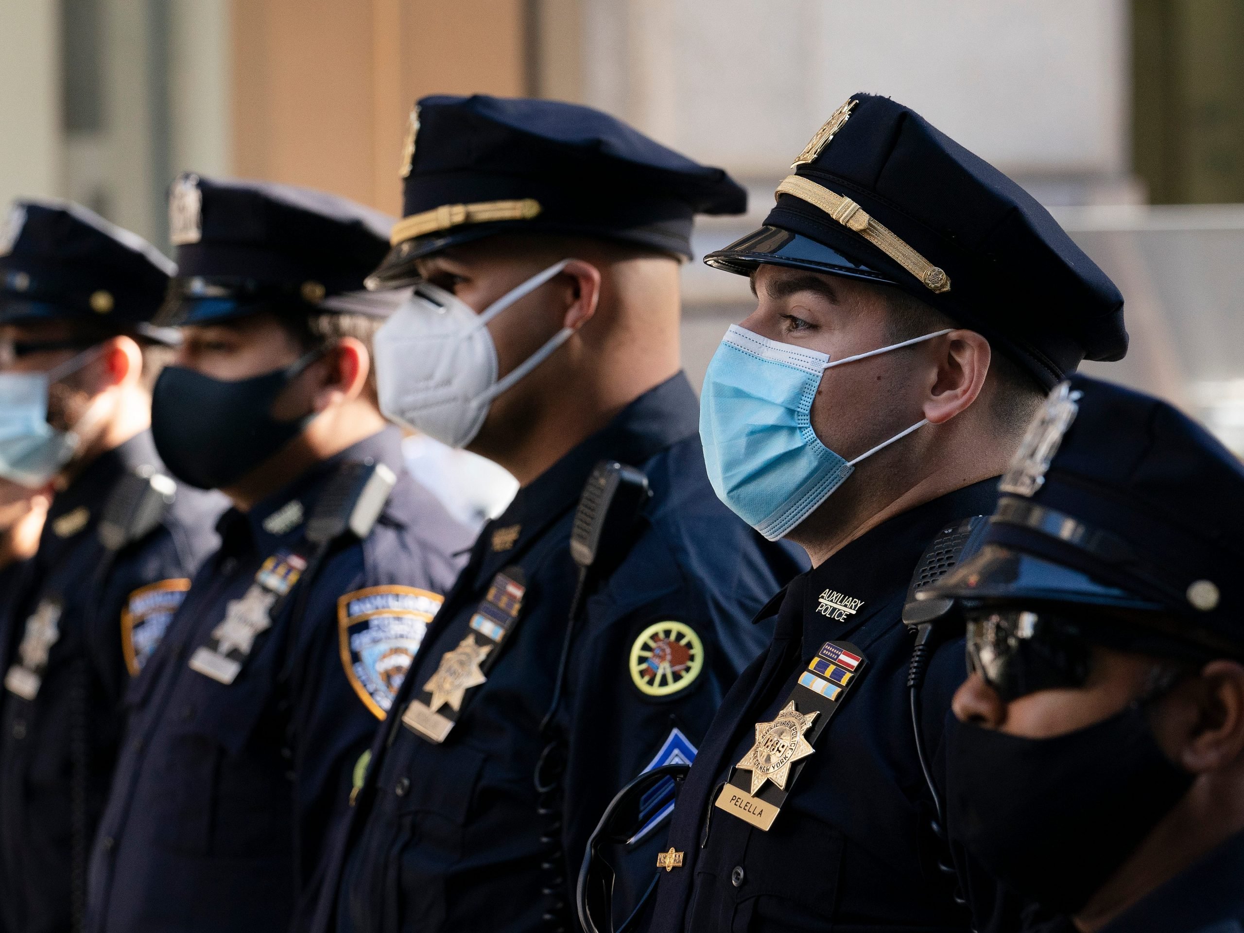 In this Oct. 5, 2020, file photo, New York Police Department officers in masks stand during a service at St. Patrick's Cathedral in New York to honor 46 colleagues who have died due to COVID-19 related illness.