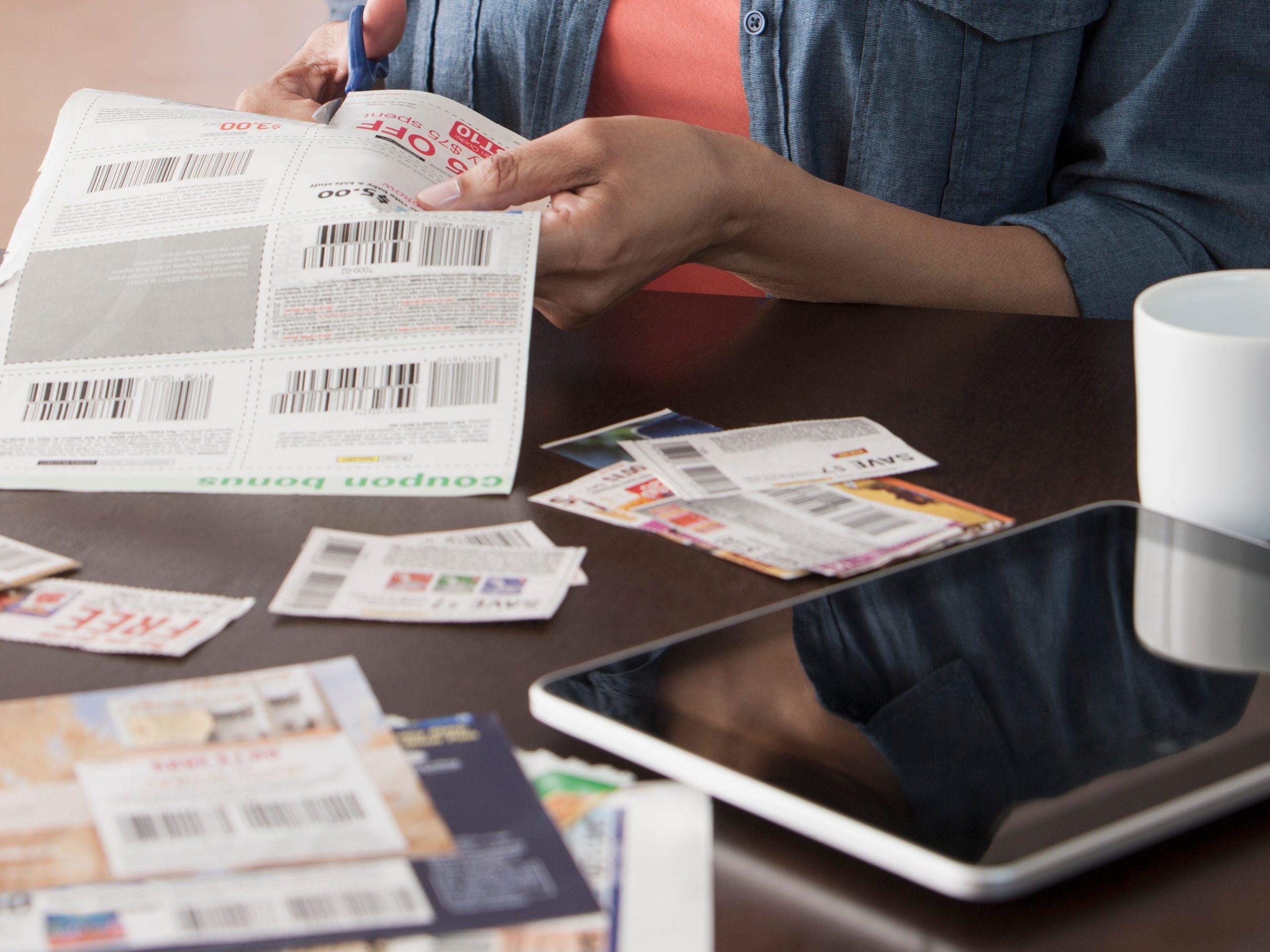 Older woman clipping coupons