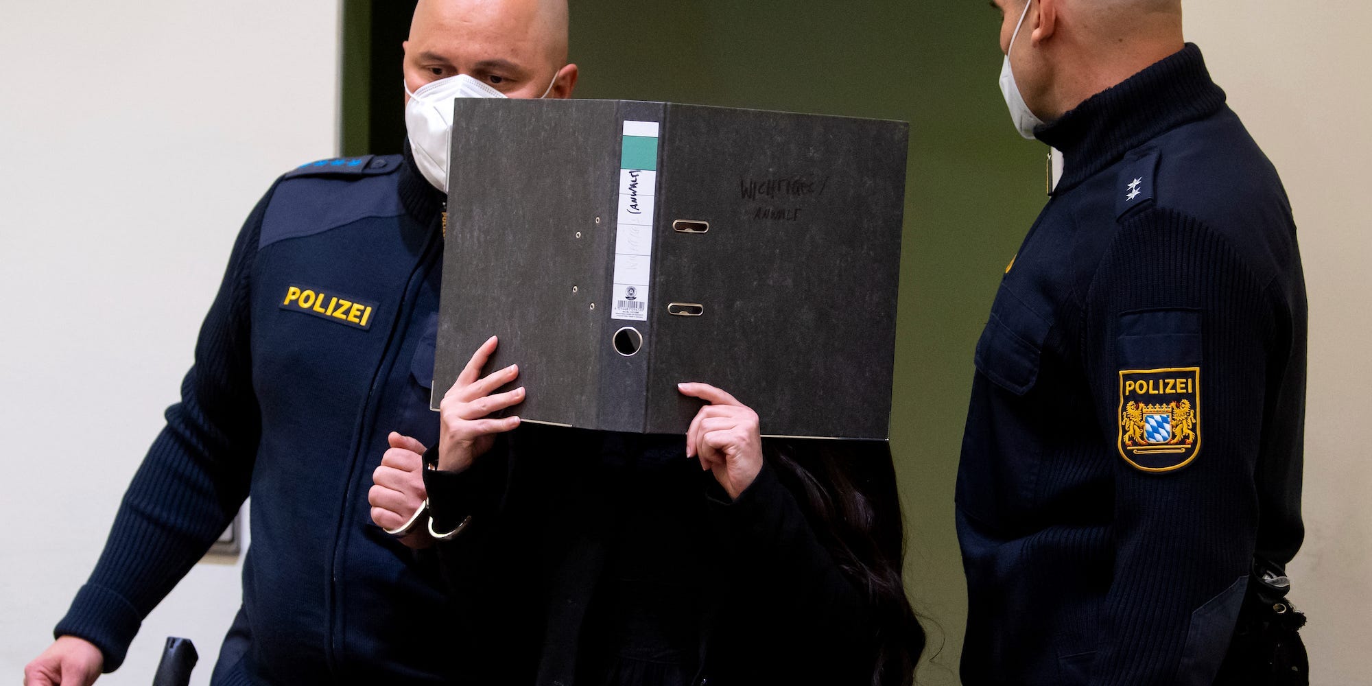 Defendant Jennifer W. arrives in a courtroom for her trial in Munich, Germany, Monday, Oct. 25, 2021.