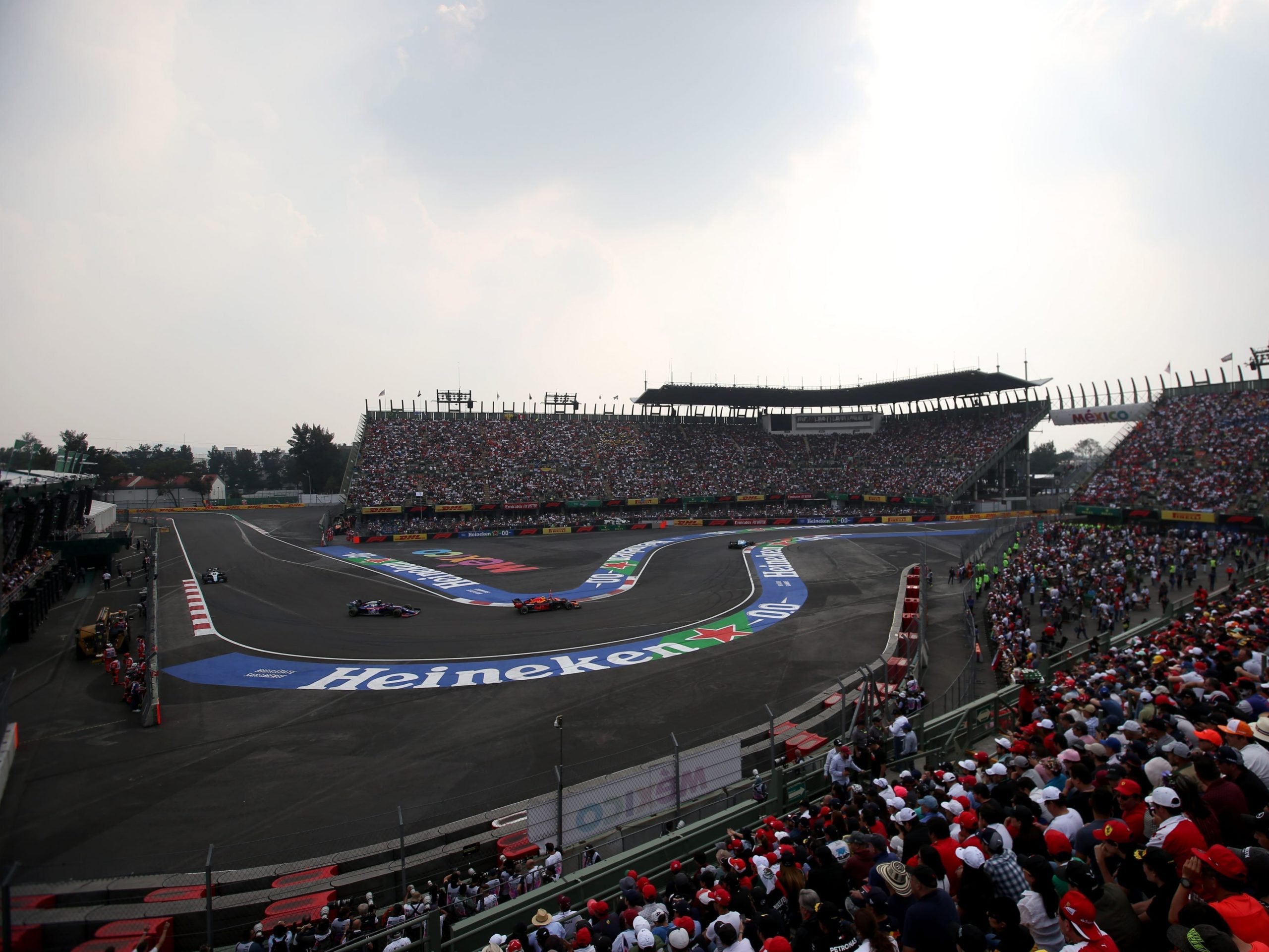 Alexander Albon of Thailand driving the (23) Aston Martin Red Bull Racing RB15 leads Pierre Gasly of France driving the (10) Scuderia Toro Rosso STR14 Honda on track during the F1 Grand Prix of Mexico