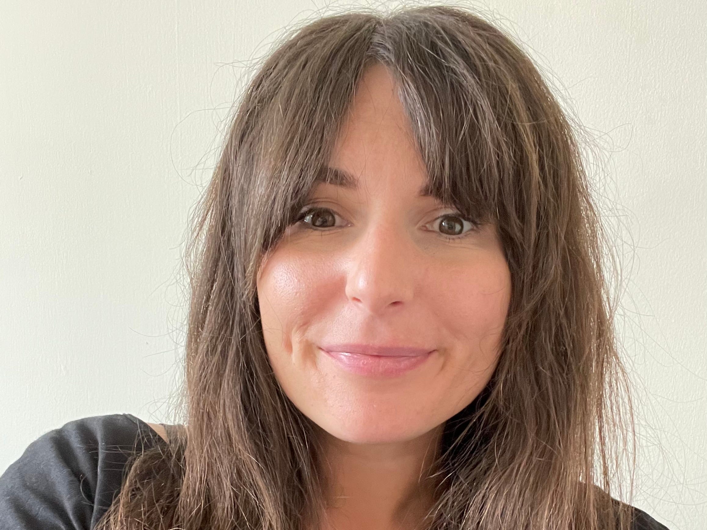 brown haired woman facing camera