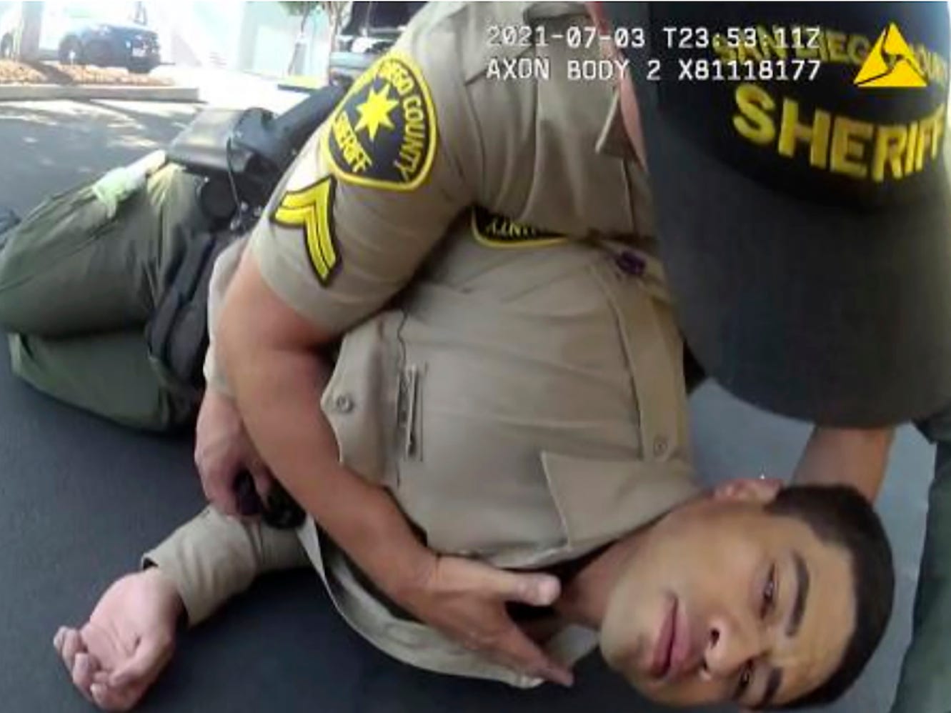 In this image taken from police body camera video and provided by the San Diego County Sheriff's Department, San Diego County Sheriff's Deputy David Faiivae gets aid from an officer, after being exposed to fentanyl on July 3, 2021 in San Diego. A public safety video that told viewers the deputy had a near-death experience after being exposed to fentanyl used the actual footage, the San Diego Sheriff's department said Monday, Aug. 9, 2021, after critics questioned the deputy's severe reaction. The video shows "an actual incident involving the deputy as he processed a white powdery substance that tested positive for Fentanyl," a department news release said. (