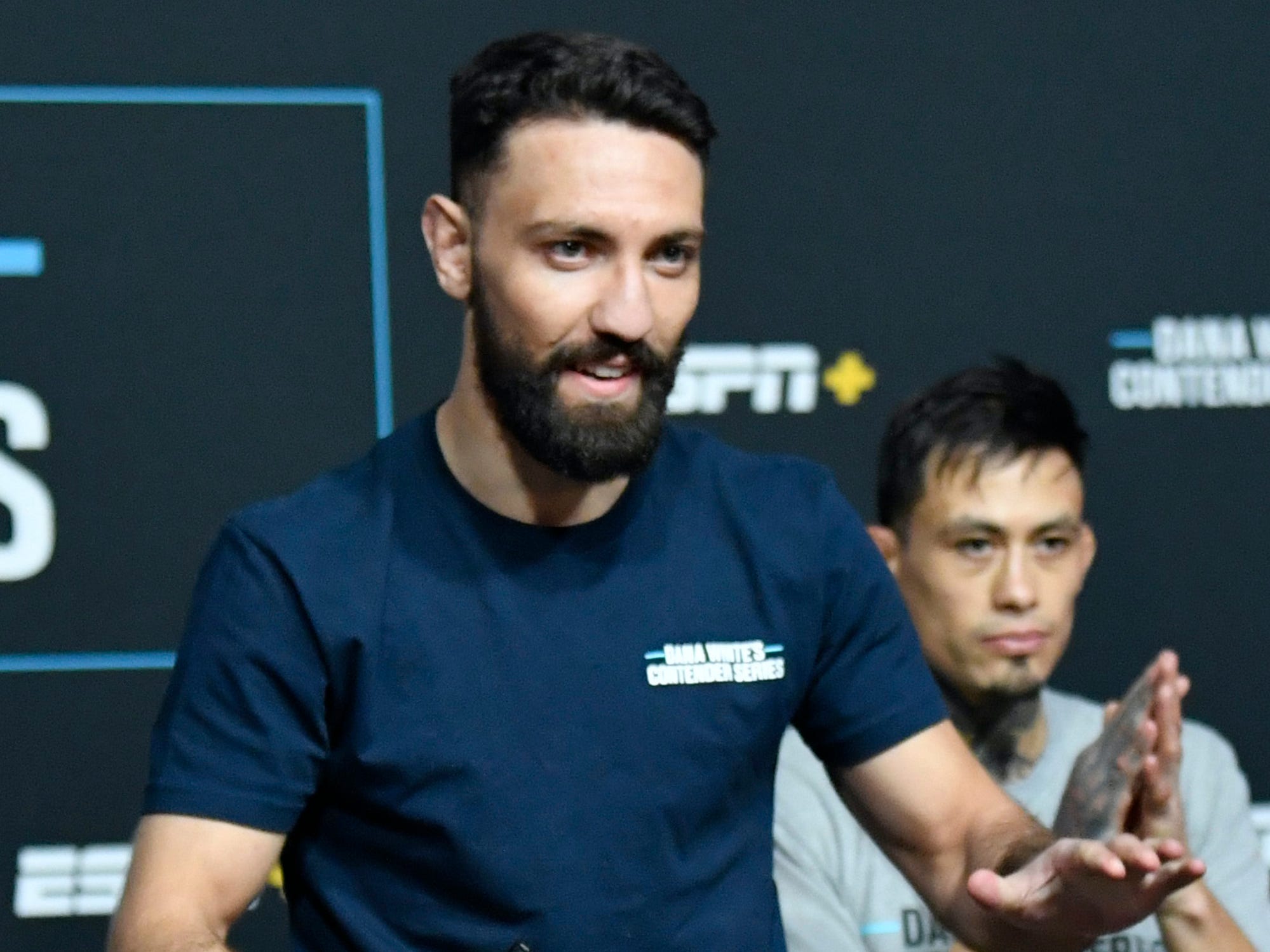 Javid Basharat jumps out of his seat to receive his UFC deal.