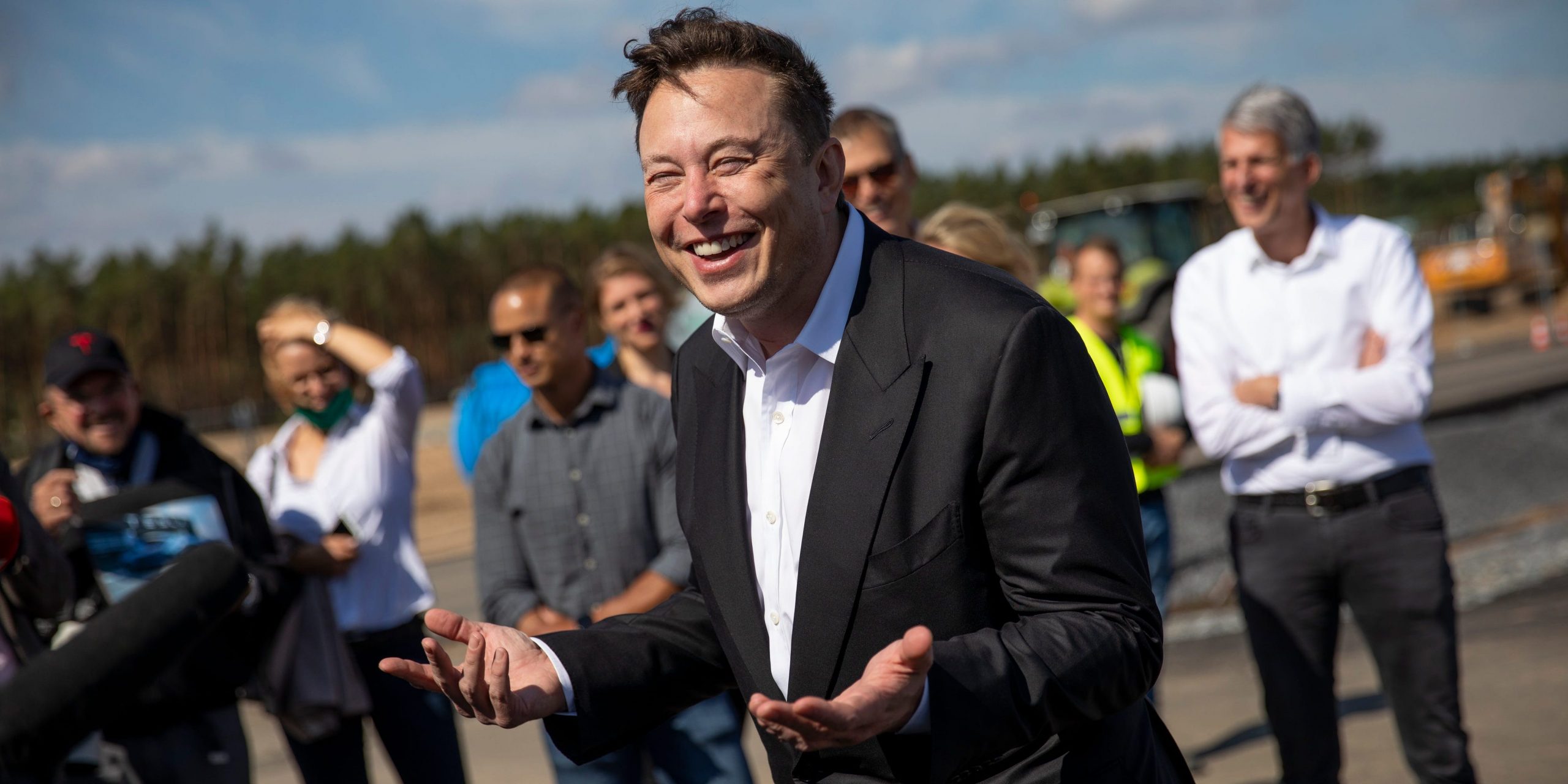 Tesla head Elon Musk talks to the press as he arrives to to have a look at the construction site of the new Tesla Gigafactory near Berlin