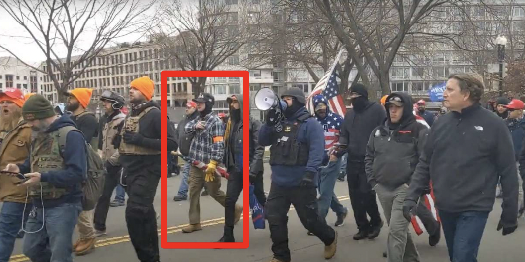 Micajah Jackson walks with a group of individuals led by Proud Boys organizer Joe Biggs, some of whom were dressed in orange, towards the U.S. Capitol on January 6, 2021