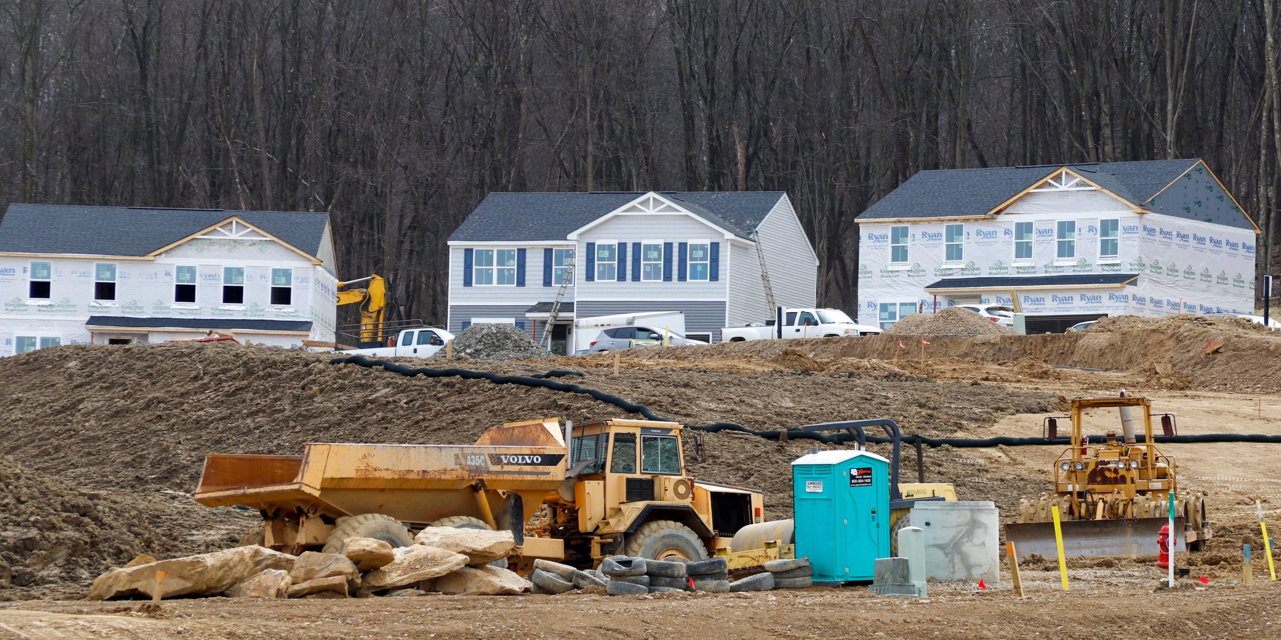 In this March 18, 2020 photo, Construction continues at a housing plan in Zelienople, Pa.,  The housing market has stalled, but homebuilder stocks are up sharply amid signs that sales are starting to improve. Still, the outlook for a housing market recovery remains cloudy, given uncertainty over the pandemic's impact. (AP Photo/Keith Srakocic)