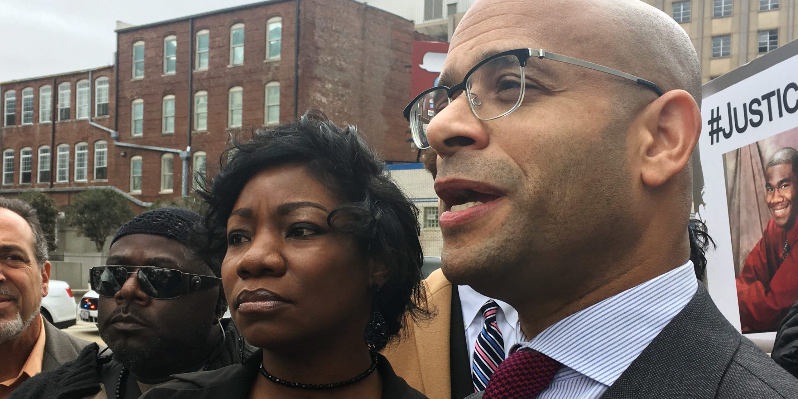 Monteria Robinson, mother of Jamarion Robinson, who was schizophrenic and shot by police in August 2016, stands with her lawyer, Andrew M. Stroth, as he addresses reporters at a news conference outside the federal courthouse, Wednesday, Jan. 10, 2018, in Atlanta.