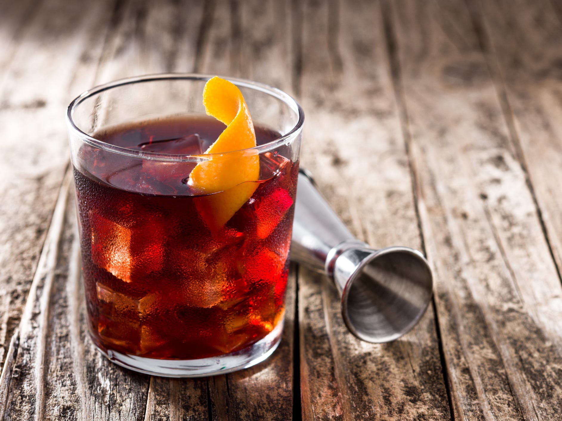 A boulevardier in a rocks glass garnished with an orange twist