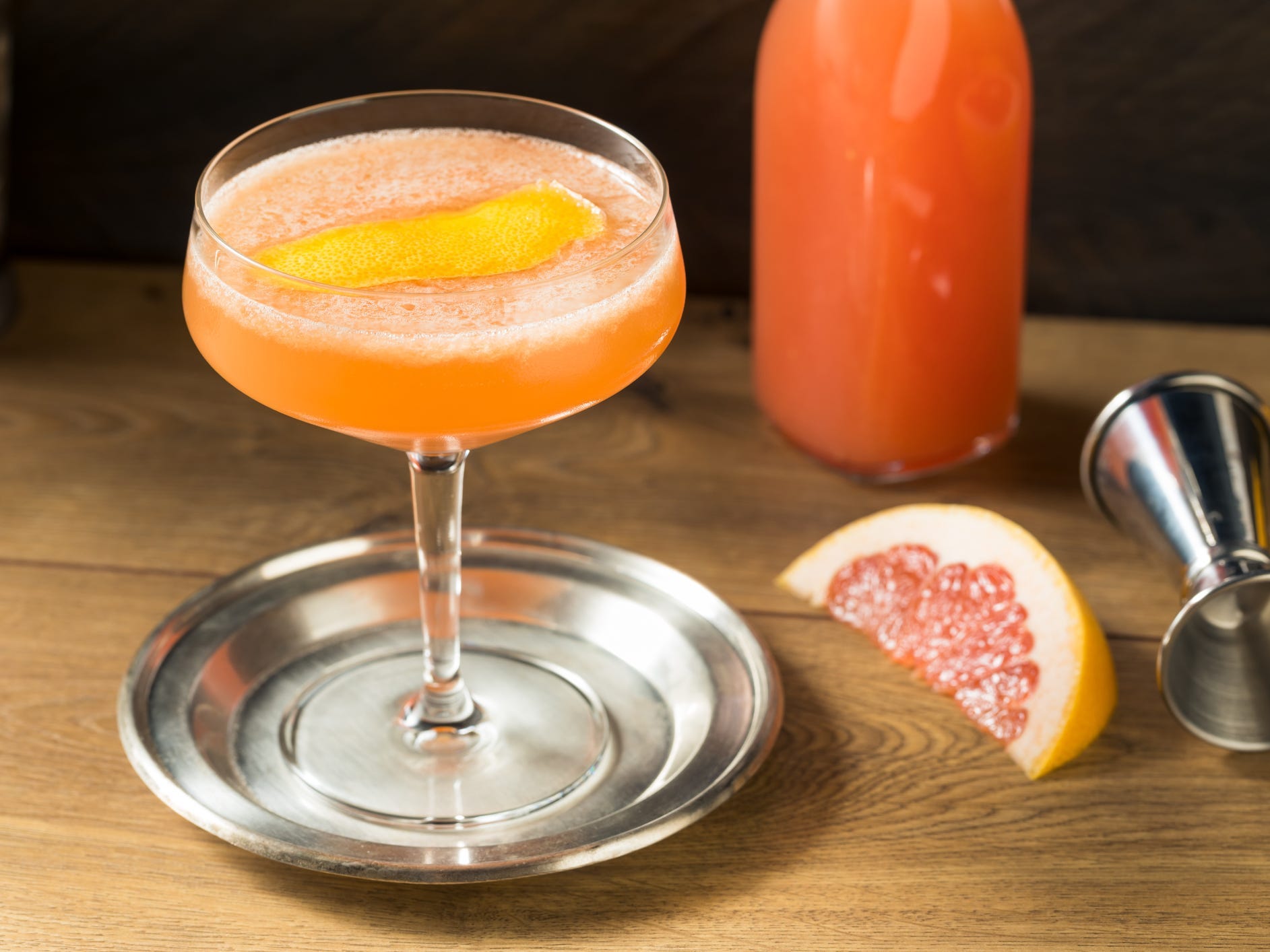 A brown derby cocktail in a coupe class on a small silver tray