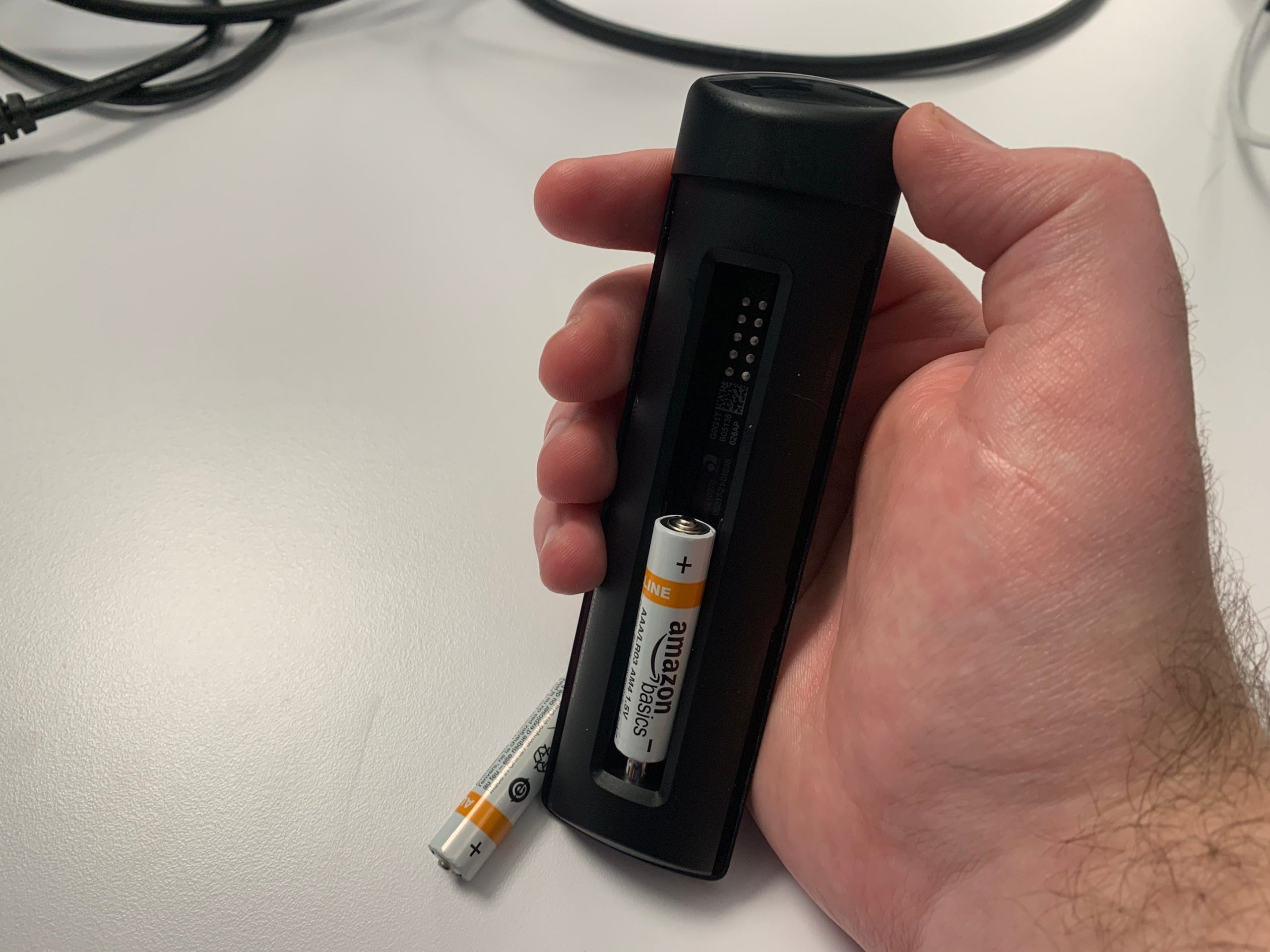 Taking the batteries out of an Amazon Firestick remote.
