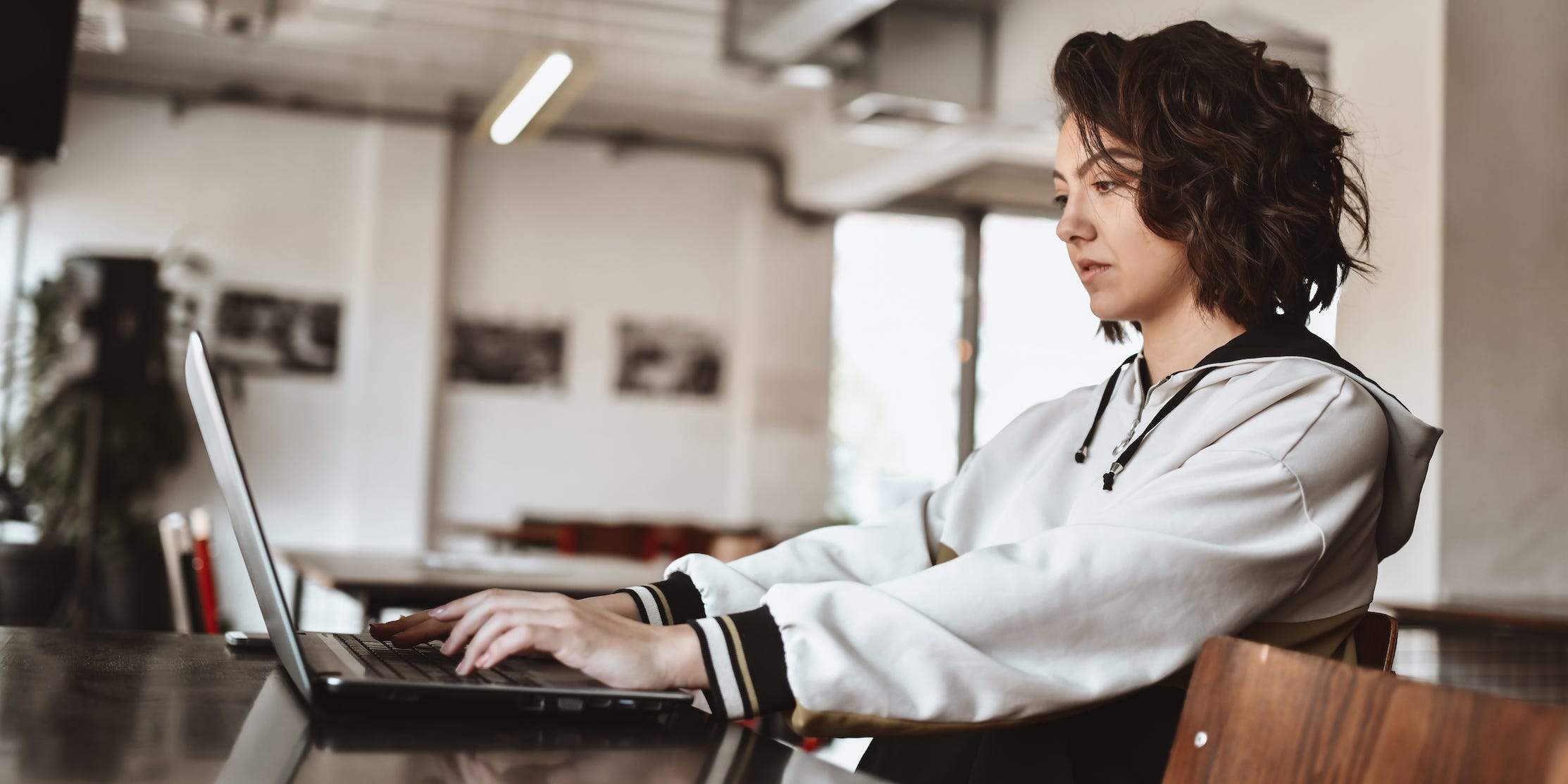 student working on laptop in cafe