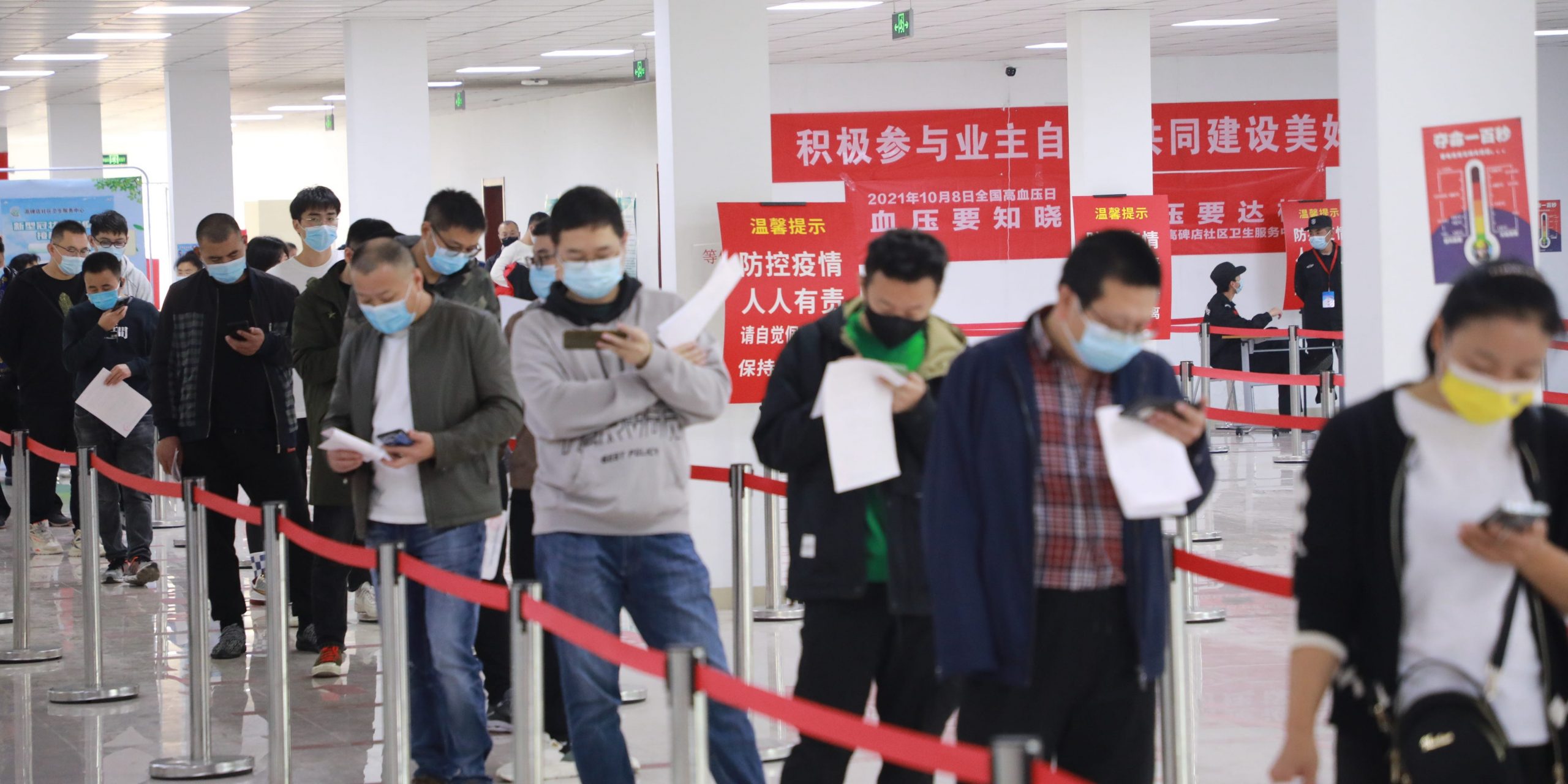 Local residents queue up to receive COVID-19 vaccine booster shots on October 30, 2021 in Beijing, China.