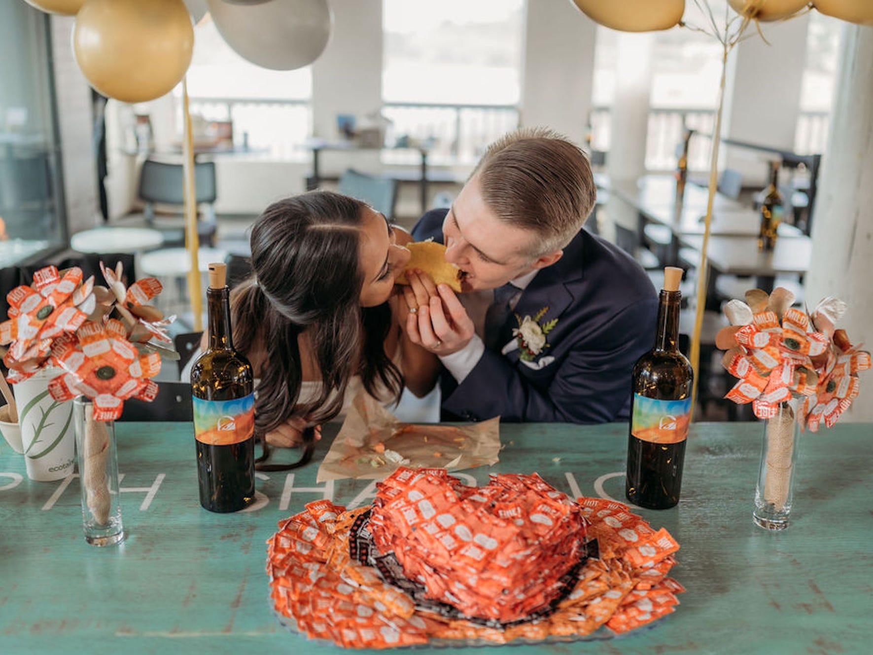 A couple shares a taco at their wedding reception at Taco Bell Cantina Pacifica.