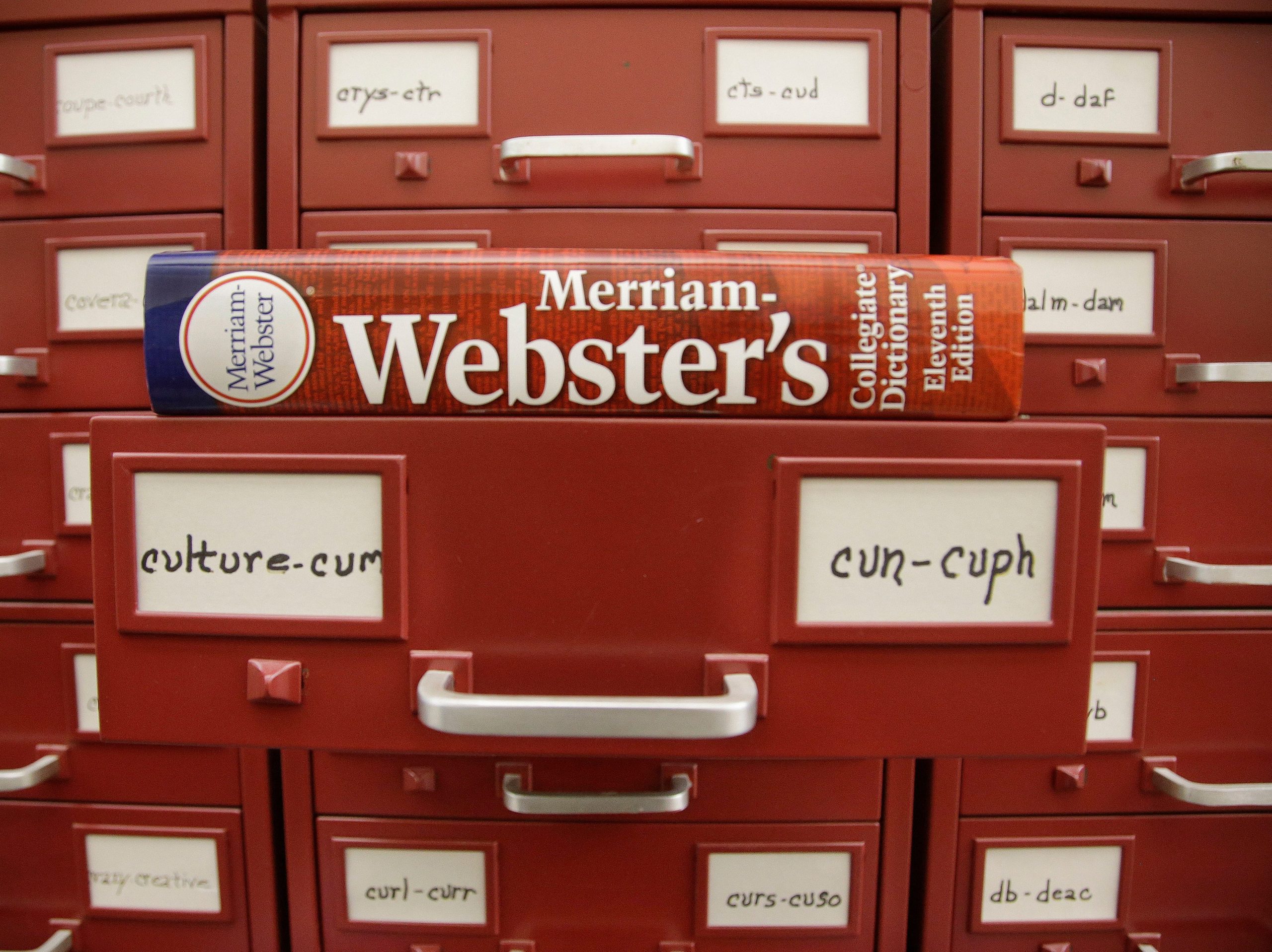 A Merriam-Webster dictionary sits atop their citation files.