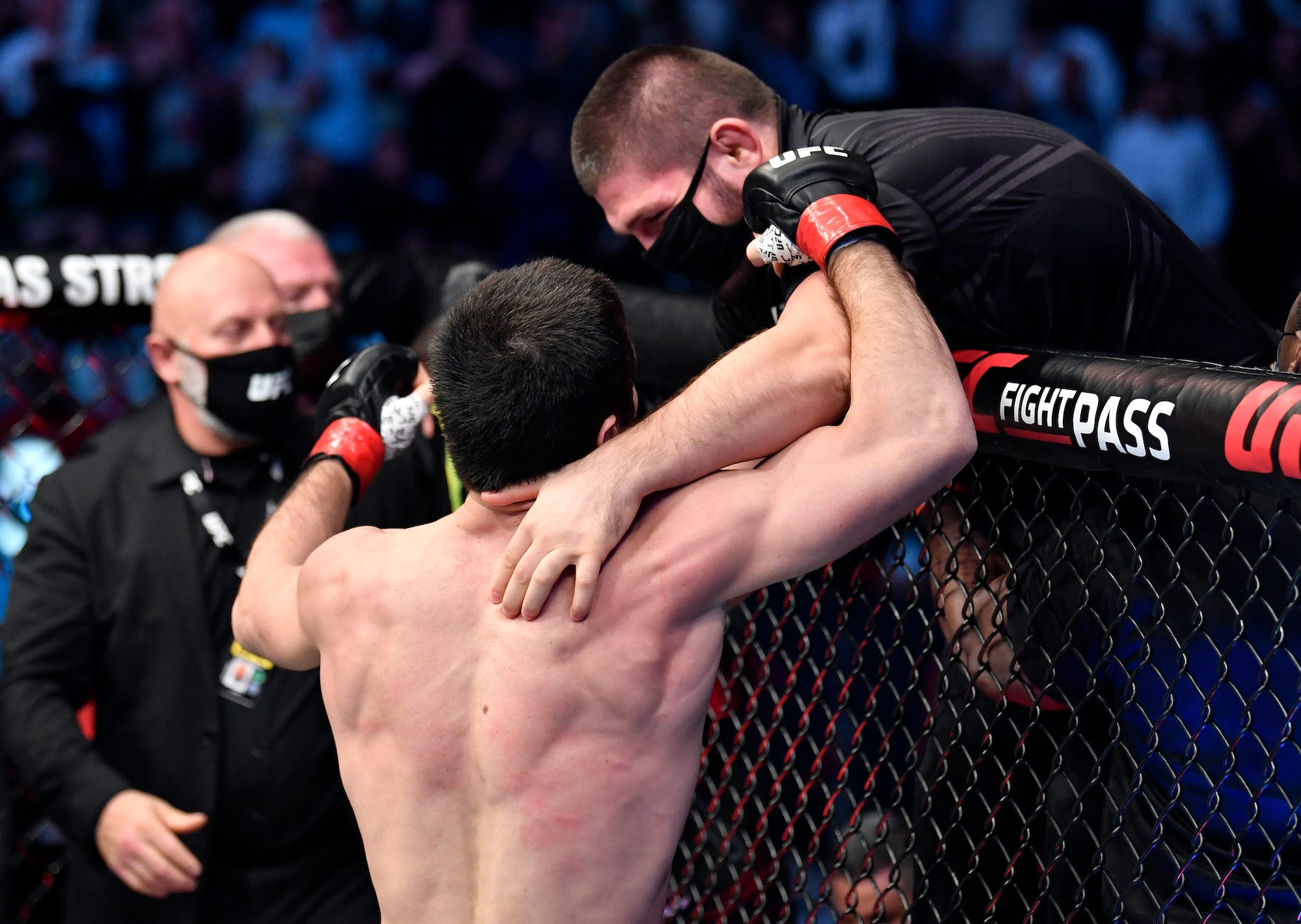 Khabib Nurmagomedov celebrates with winning MMA fighter Islam Makhachev.