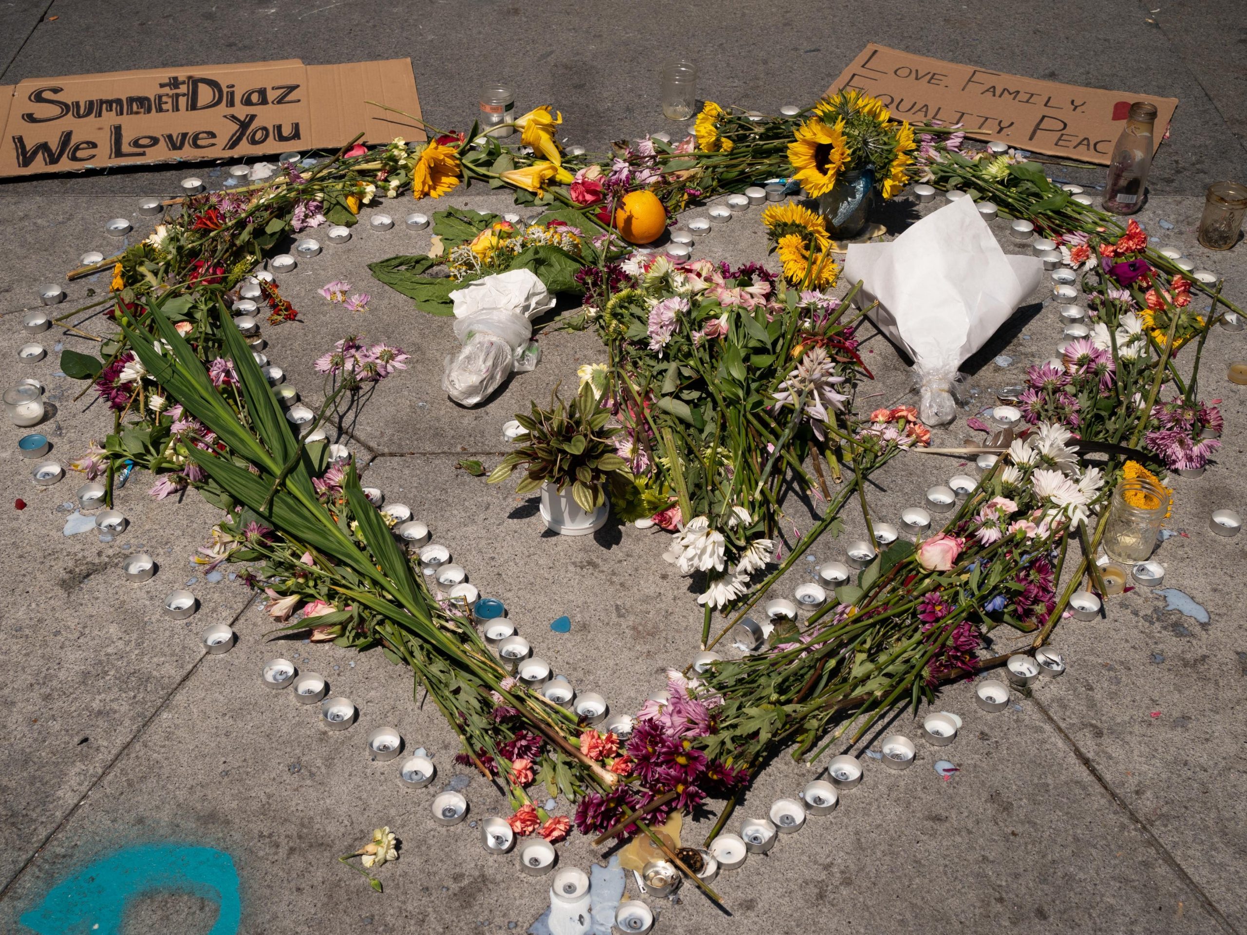 A memorial of flowers and candles is pictured in Westlake Park to honor the two victims hit by a car during a recent protest, including Summer Taylor, who died yesterday, and Diaz Love, who is in serious condition in the hospital, on July 5, 2020 in Seattle, Washington. A driver struck the protesters on Interstate 5 in Seattle.