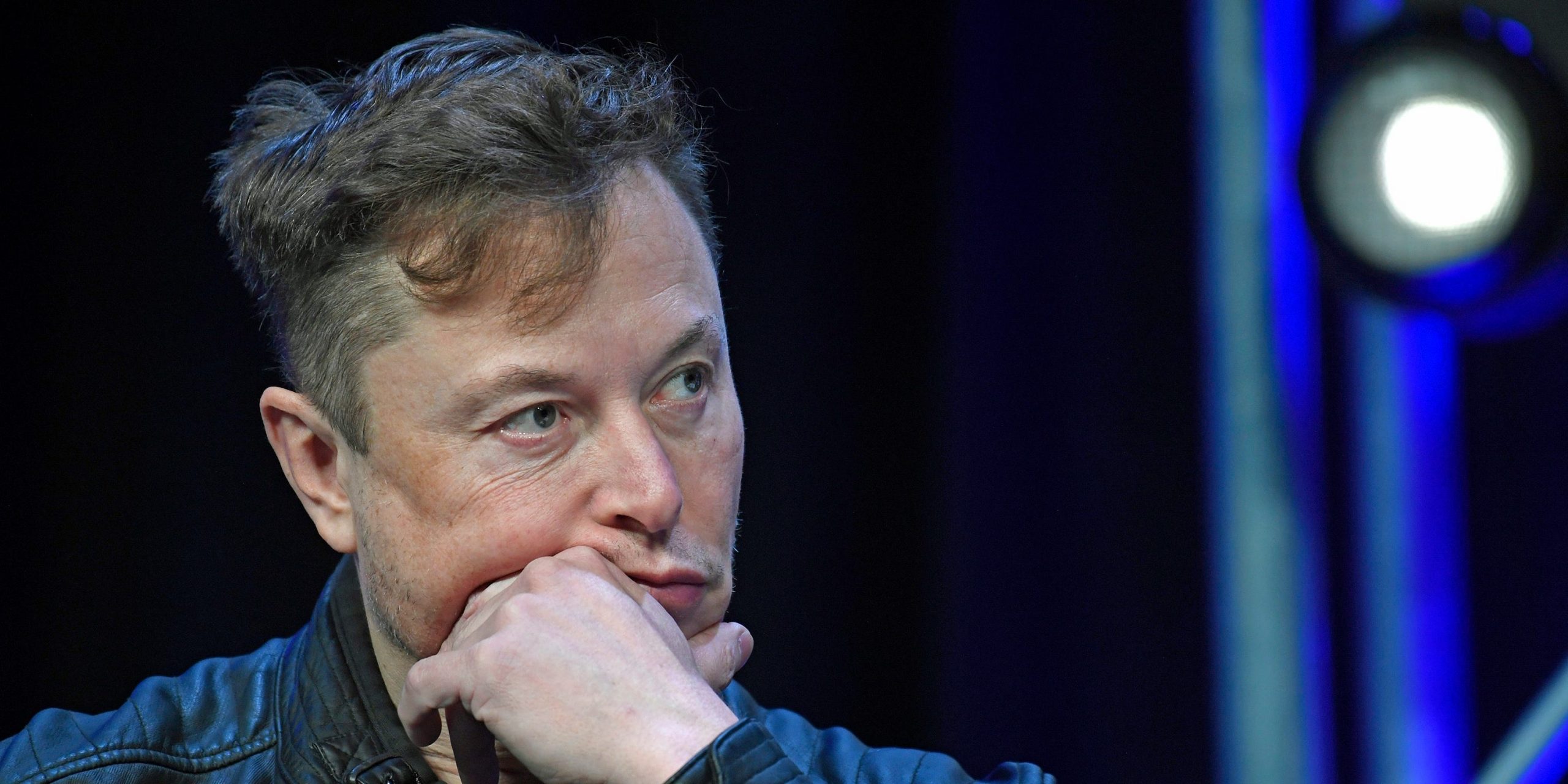 Elon Musk SpaceX Tesla CEO holds hand to face thinking