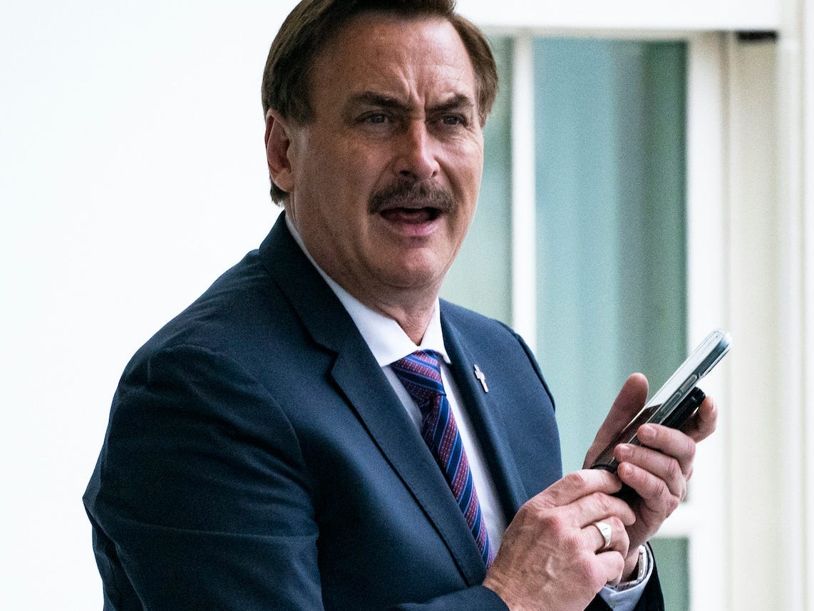 MyPillow CEO Mike Lindell holding a phone outside the White House