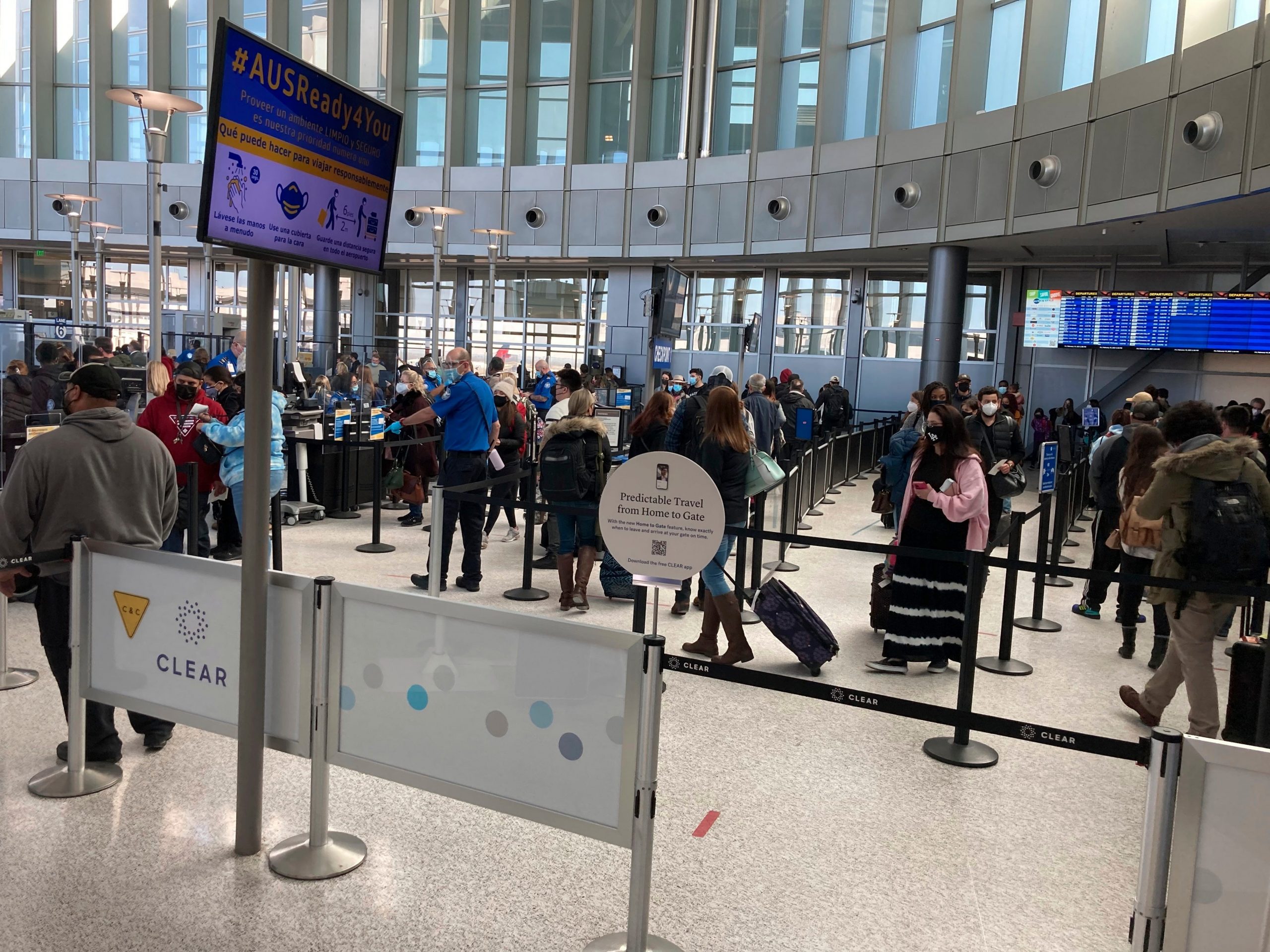 Travelers stand in line at a TSA security checkpoint at Austin-Bergstrom International Airport Friday, Feb. 19, 2021, in Austin, Texas.