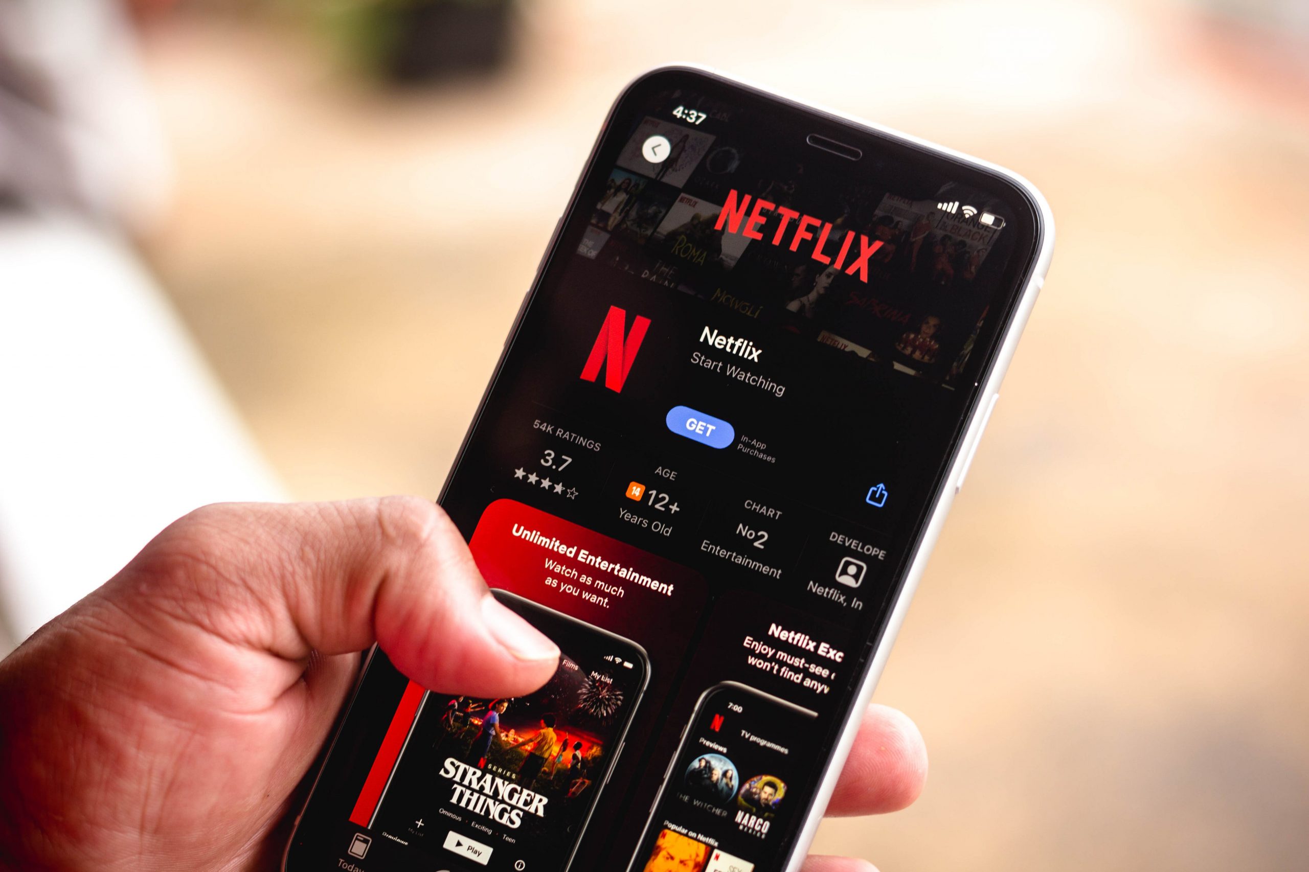 a person downloading netflix on their phone