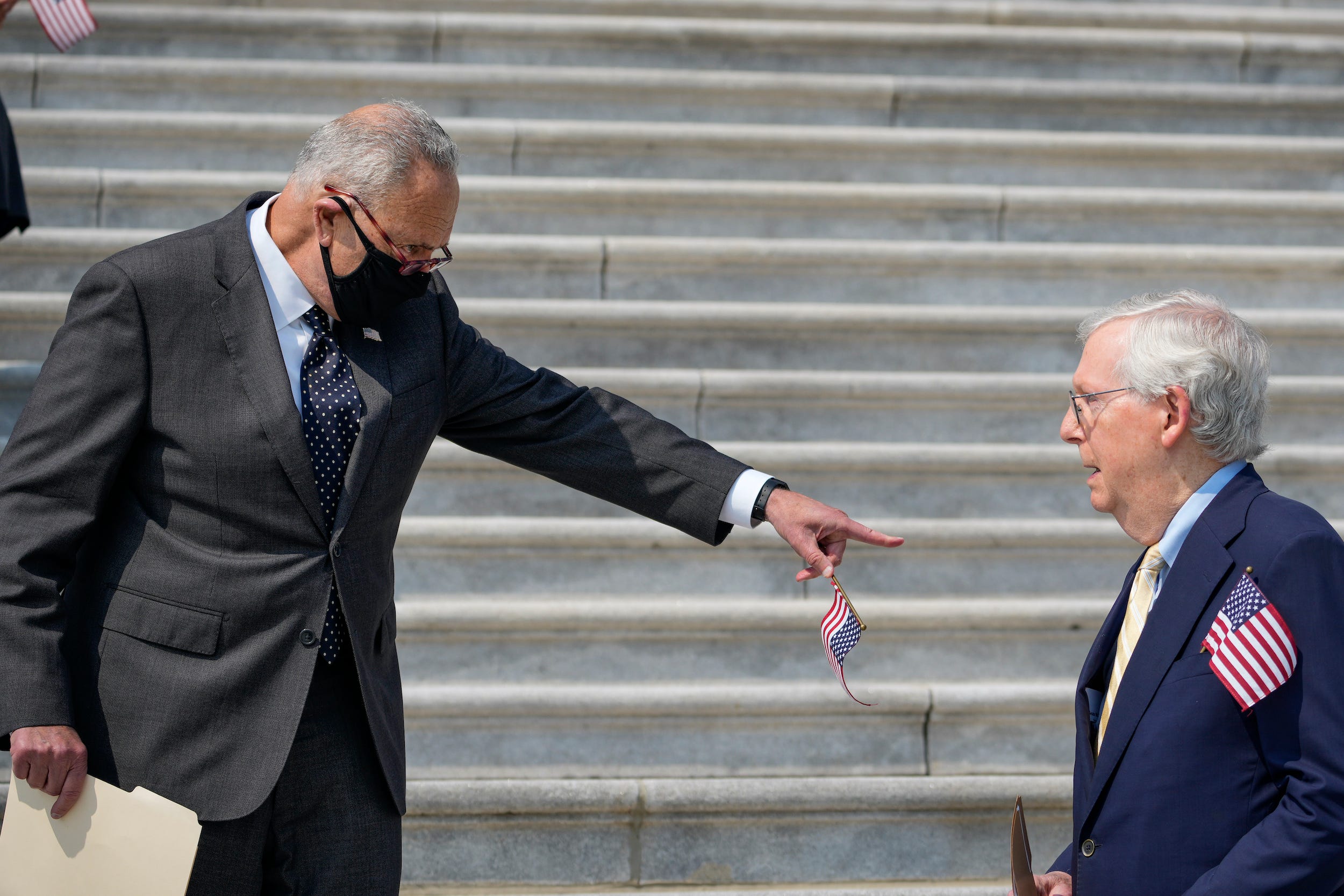 Senate Majority Leader Chuck Schumer (D-NY) points at Senate Minority Leader Mitch McConnell as they arrive for a remembrance ceremony marking the 20th anniversary of the 9/11 terror attacks on the steps of the U.S. Capitol, on September 13, 2021 in Washington, DC.