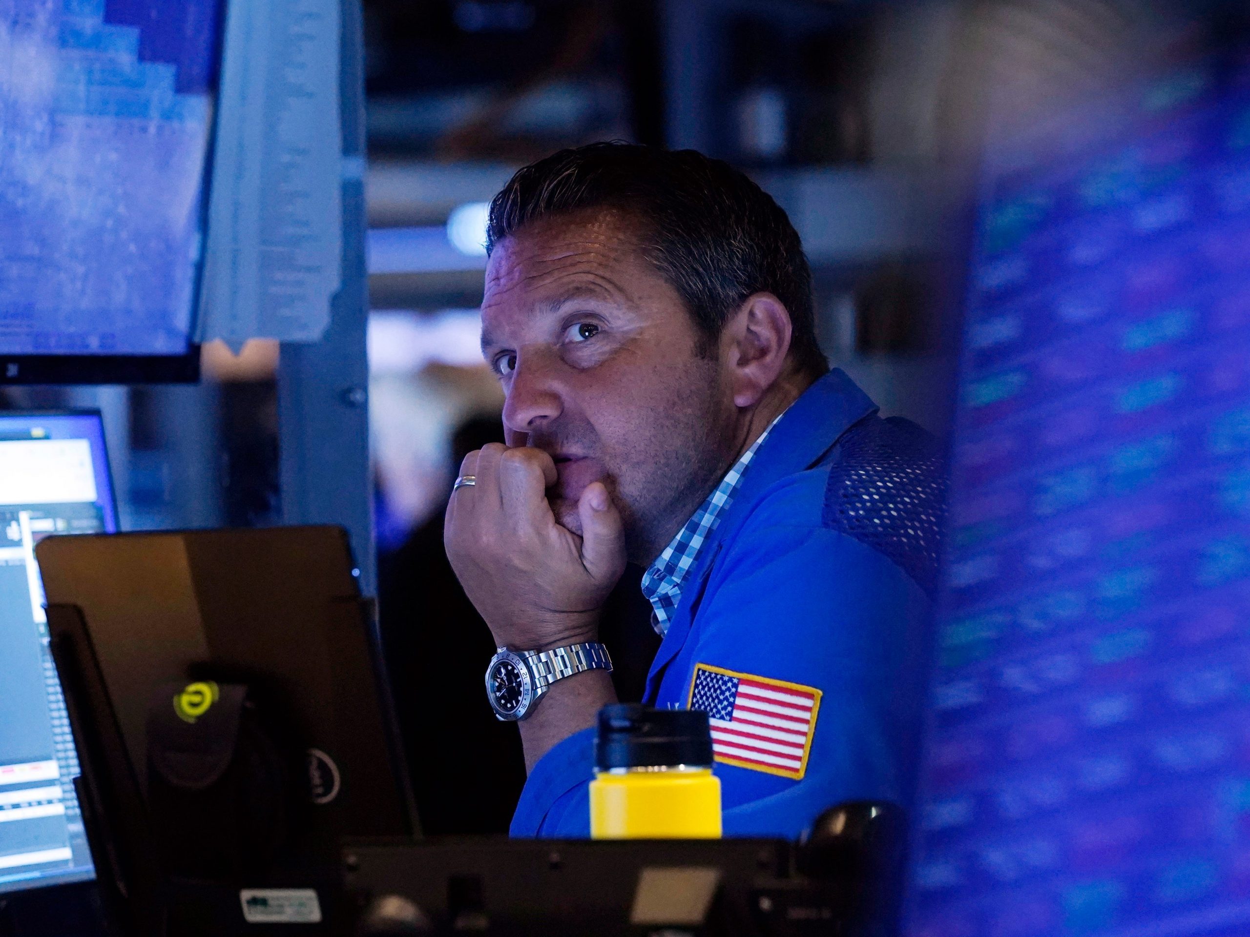 A trader sits in front of a computer monitor on the floor of the New York Stock Exchange.