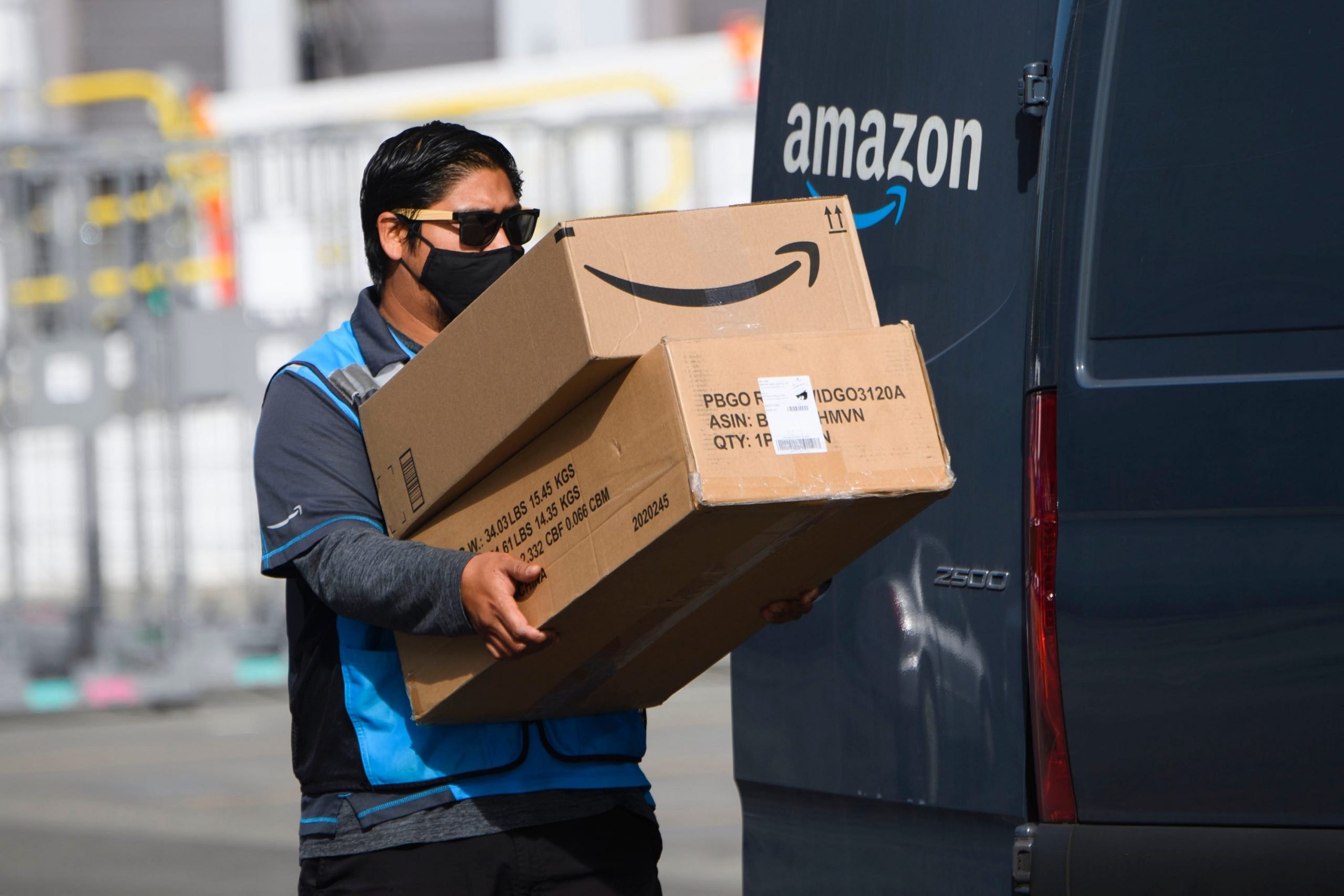 An Amazon driver carrying packages.