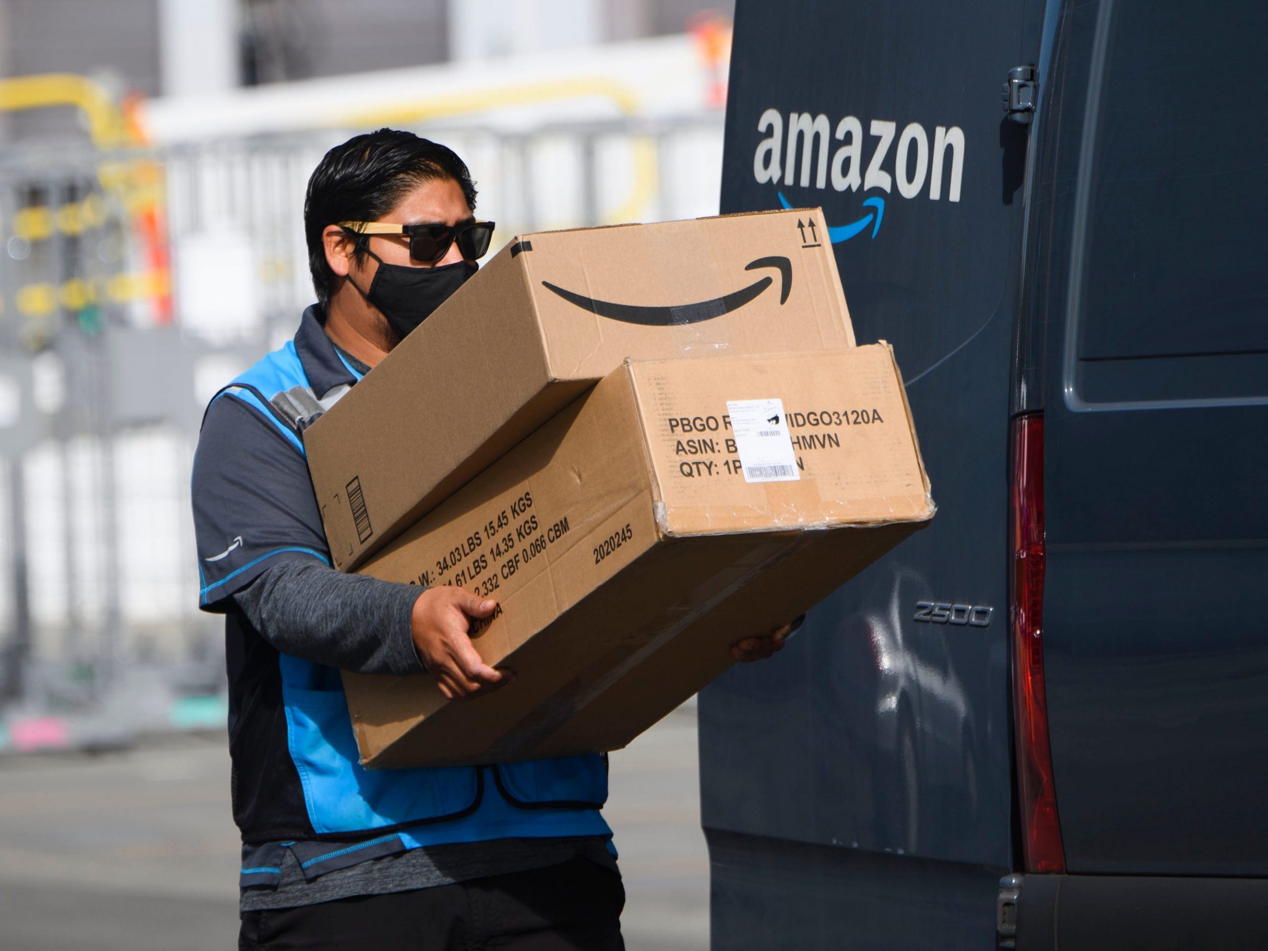 An Amazon driver carrying packages.