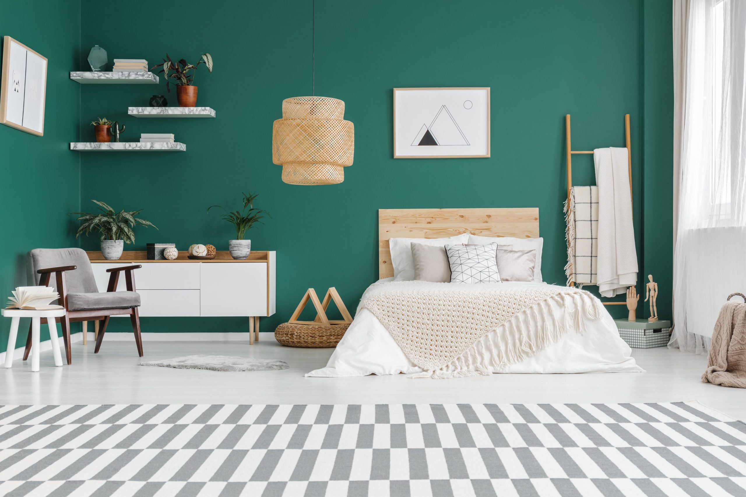 A bedroom with a green wall and checkered floor