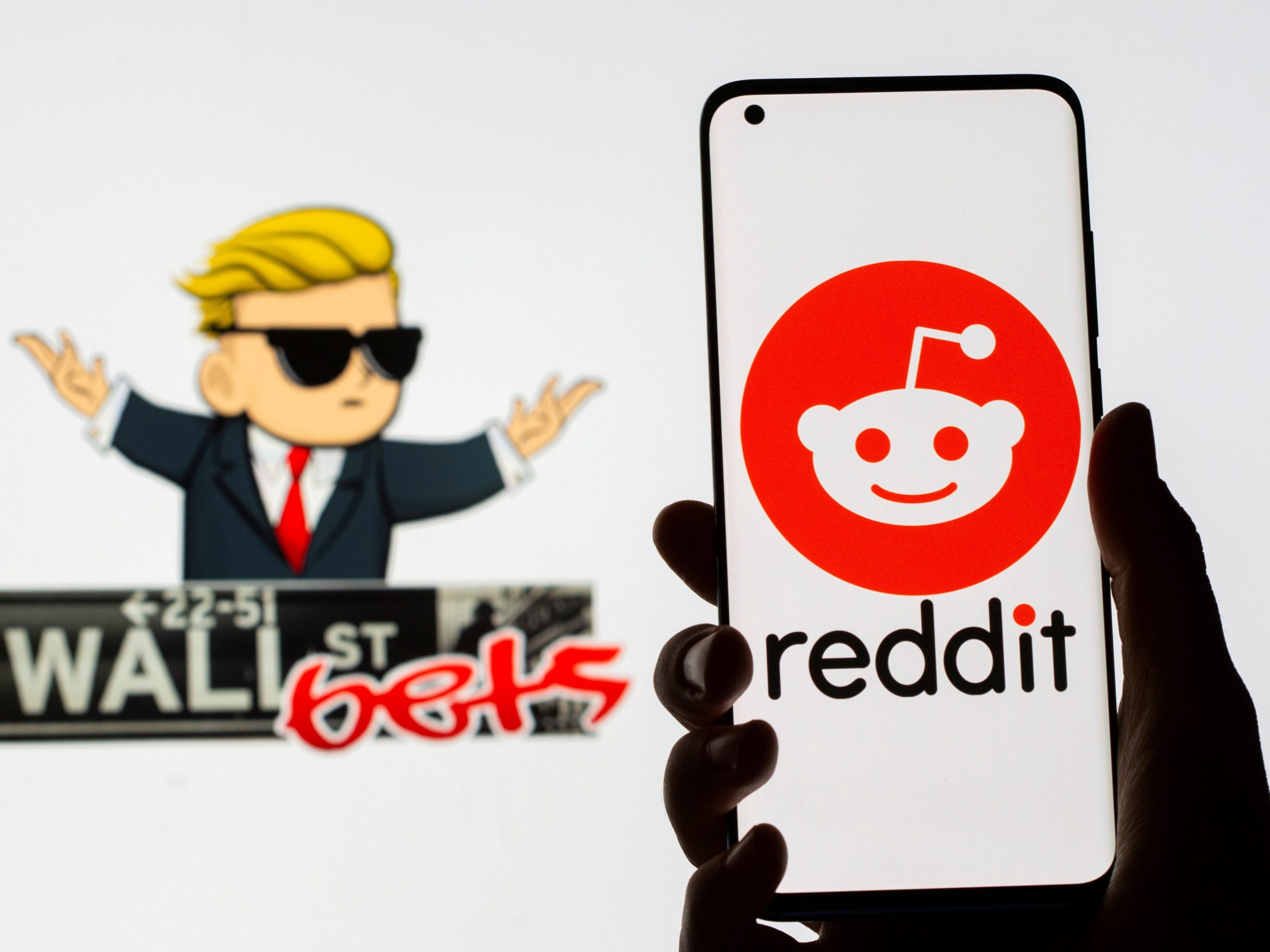 The Reddit logo is seen on a smartphone in front of a displayed Wall Street Bets logo in this illustration taken January 28, 2021.